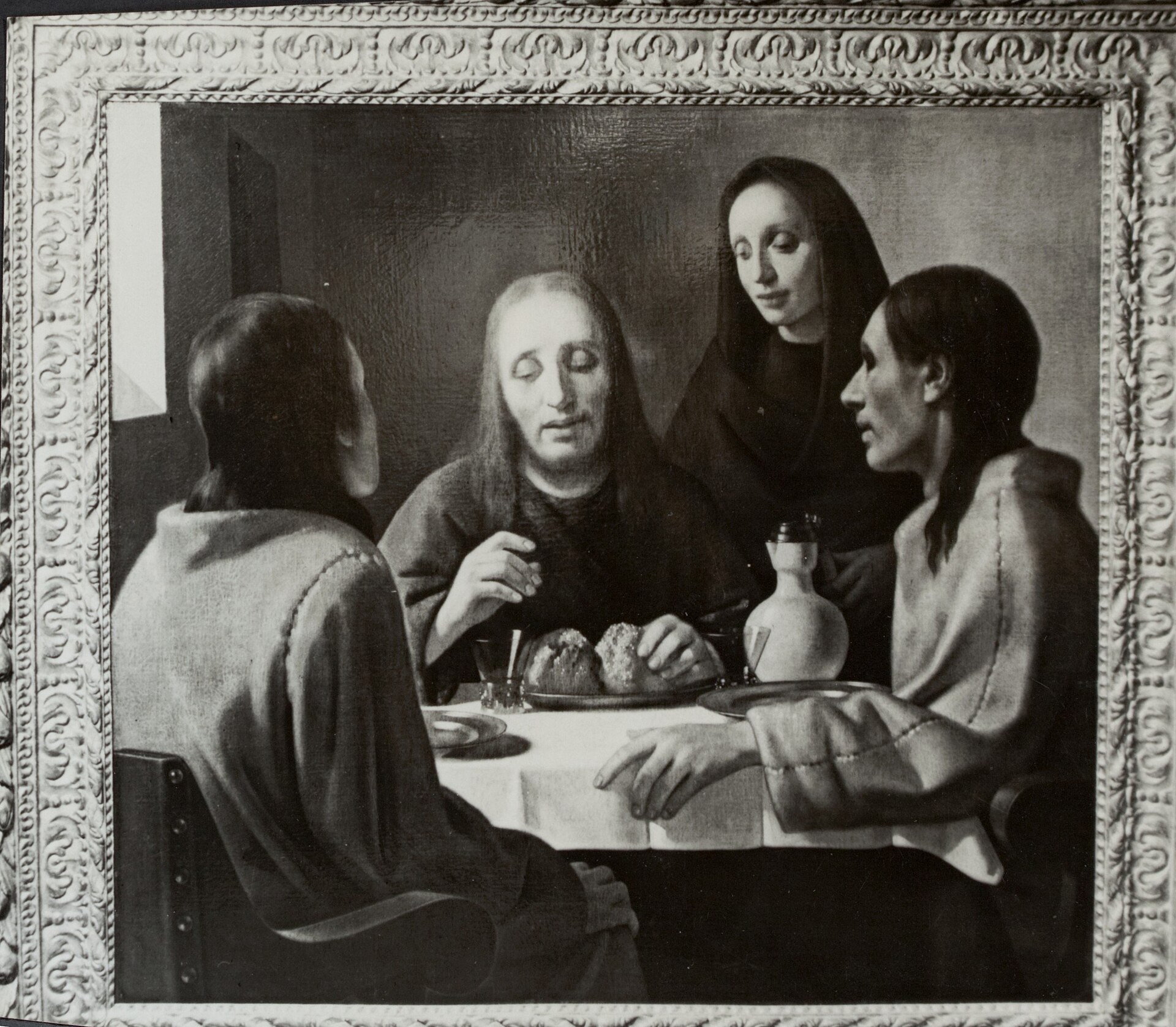 The Supper at Emmaus, oil on canvas, photographed for the Netherlands Government Information Service in October 1945. It is a forgery by Han van Meegeren, painted in 1937: not by Johannes Vermeer, and not a copy of any Vermeer, but the missing evidence for Abraham Bredius's published argument that Vermeer had an early religious phase shaped by Italian models. Bredius examined it in September 1937 and published it in The Burlington Magazine as the masterpiece of Vermeer of Delft. Museum Boijmans Van Beuningen in Rotterdam still holds it, under van Meegeren's own name and dated 1937, inventory St 1; the museum's collection record gives the acquisition year as 1939 while its accompanying text describes a purchase made in 1937, and that gap is unexplained in the published entry.