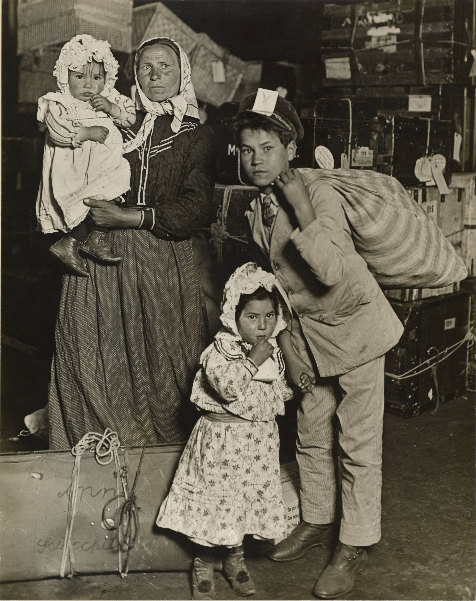 Immigrant family in the baggage room of Ellis Island