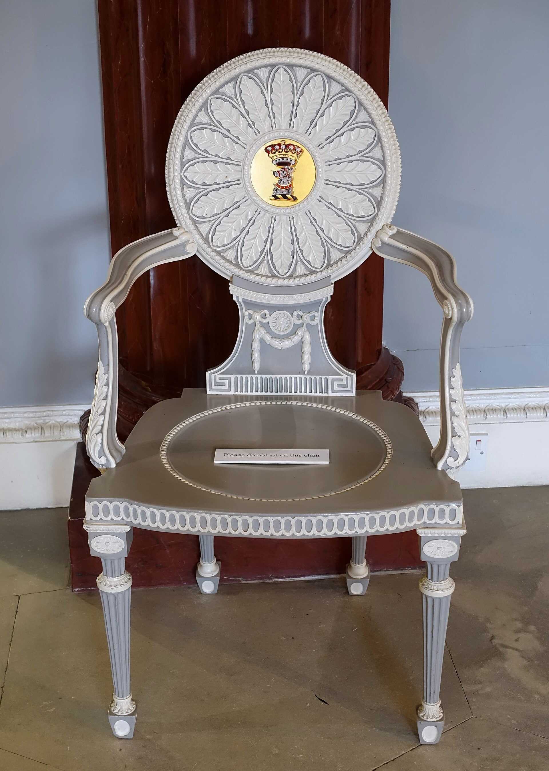 A hall chair with the patron's crest
