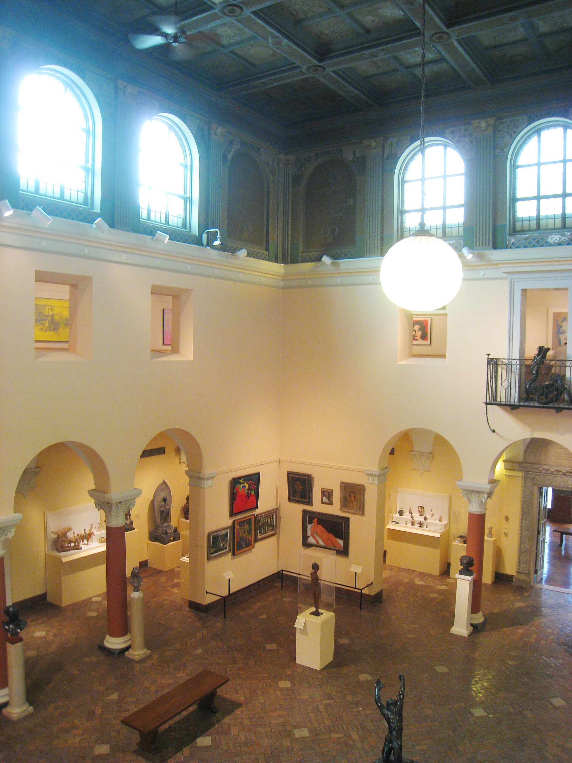 The central rotunda of the Allen Memorial Art Museum, with its painted coffered ceiling, arcaded upper gallery and classical sculpture on pedestals around the ground floor