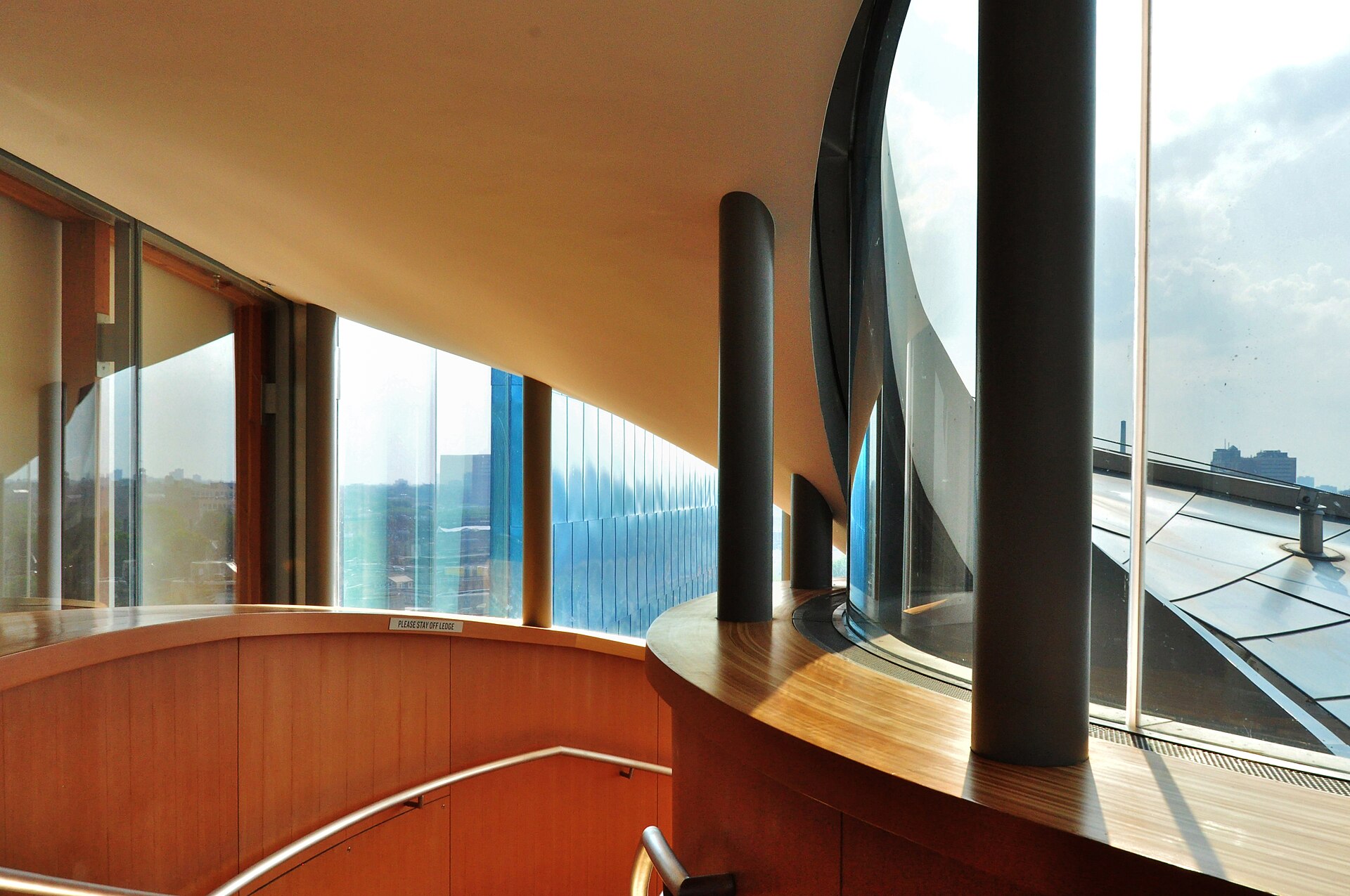 The curved wood-panelled staircase inside the Art Gallery of Ontario, designed by Frank Gehry
