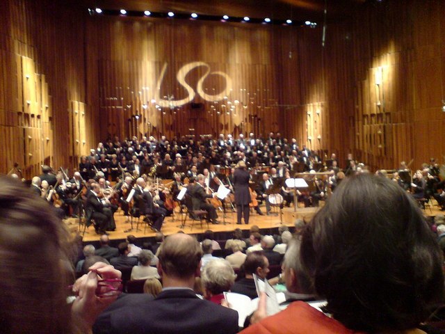 The London Symphony Orchestra and London Symphony Chorus on stage in Barbican Hall, seen from the stalls