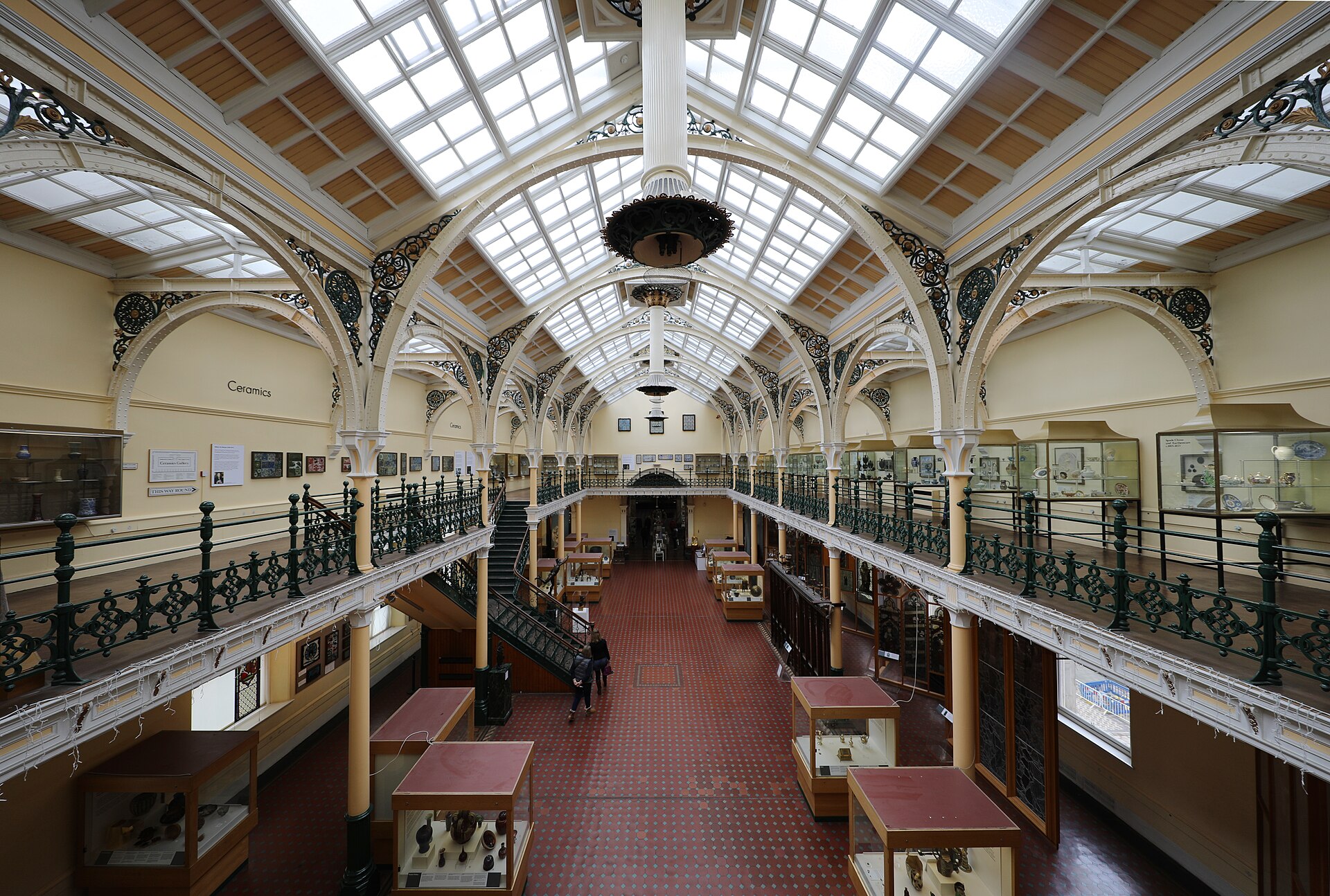 The two-tier Industrial Gallery, its glazed roof and iron arches lit from above, with display cases below