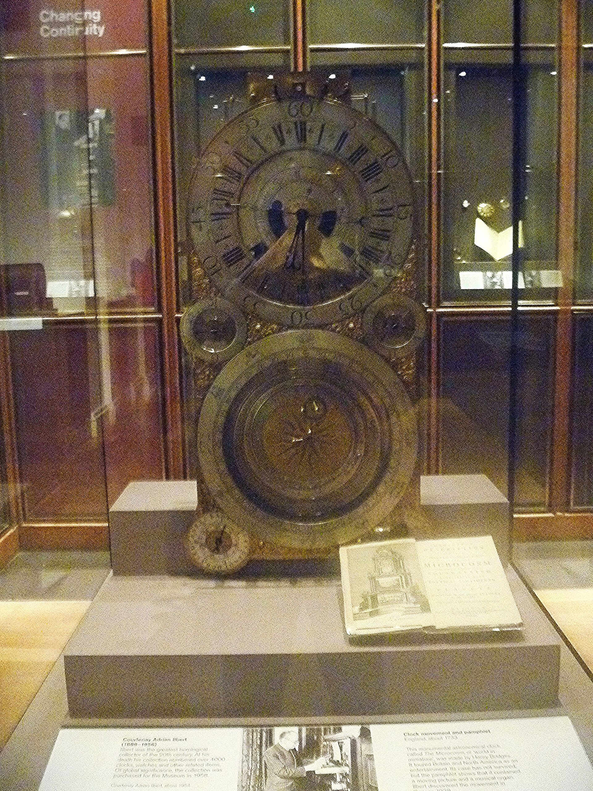 Clocks and watches gallery, an astronomical clock movement on a plinth before glazed wall cases