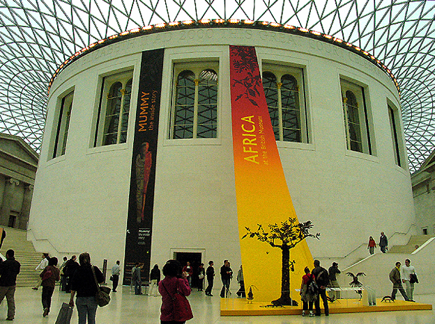 The drum of the Round Reading Room standing inside the Great Court, banners hung on its wall