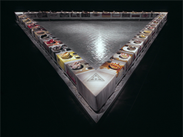 The triangular table of Judy Chicago's The Dinner Party, installed in the Sackler Center