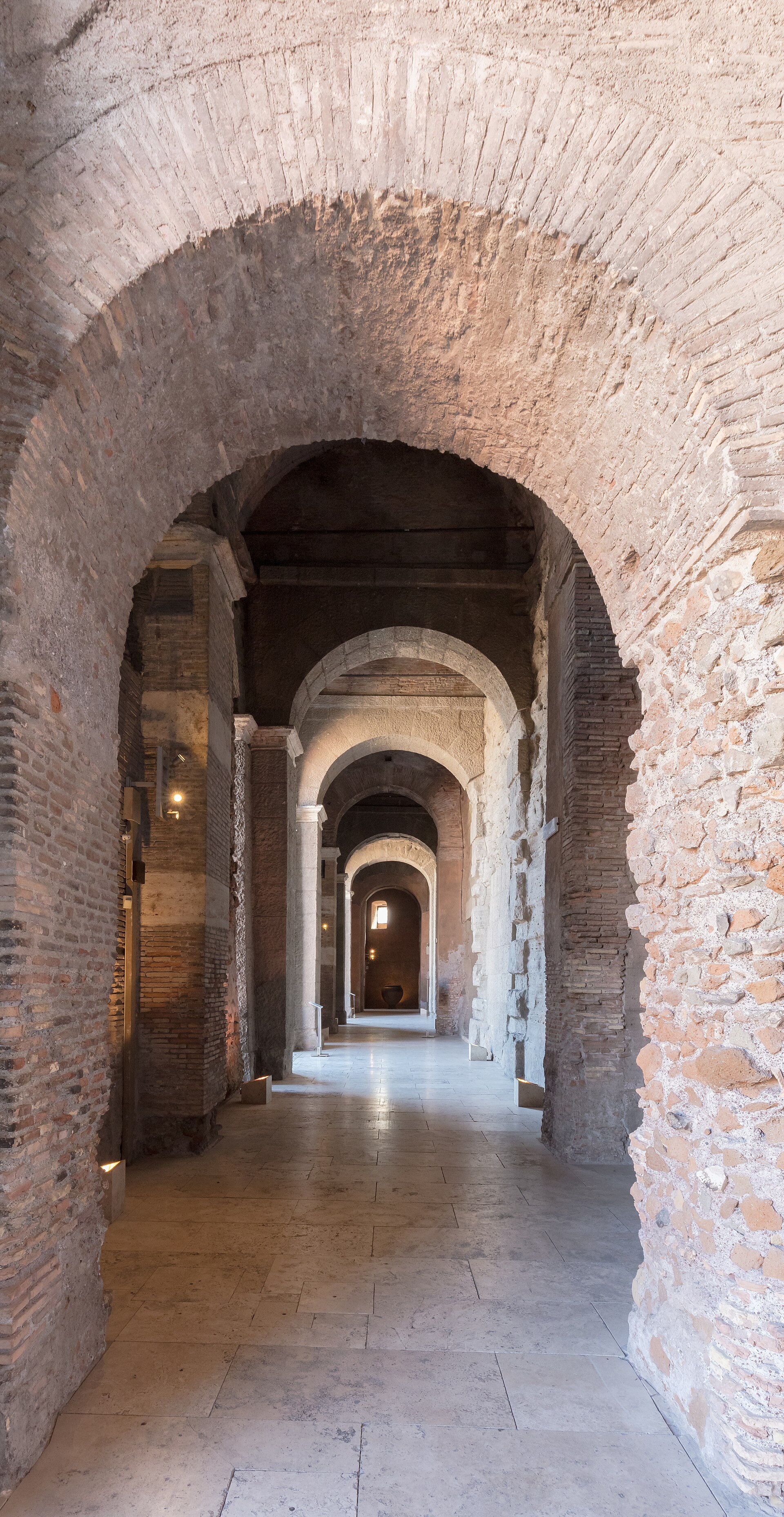 A vaulted brick and stone Roman-era corridor with a receding series of arches, part of the underground passage connecting the two palaces