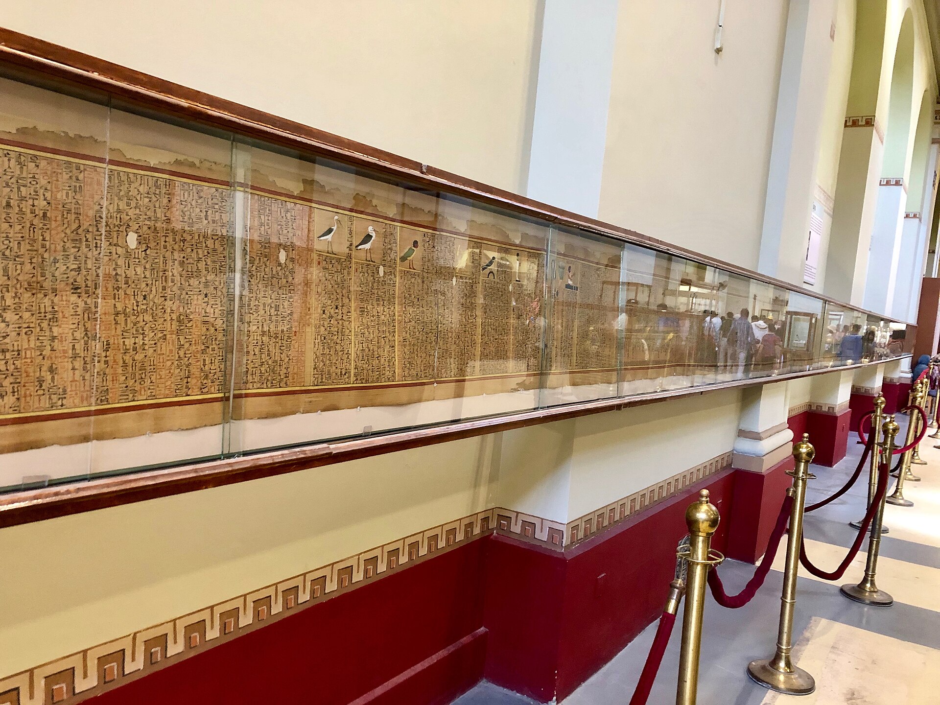 A Book of the Dead papyrus in a long horizontal wall case on the upper floor