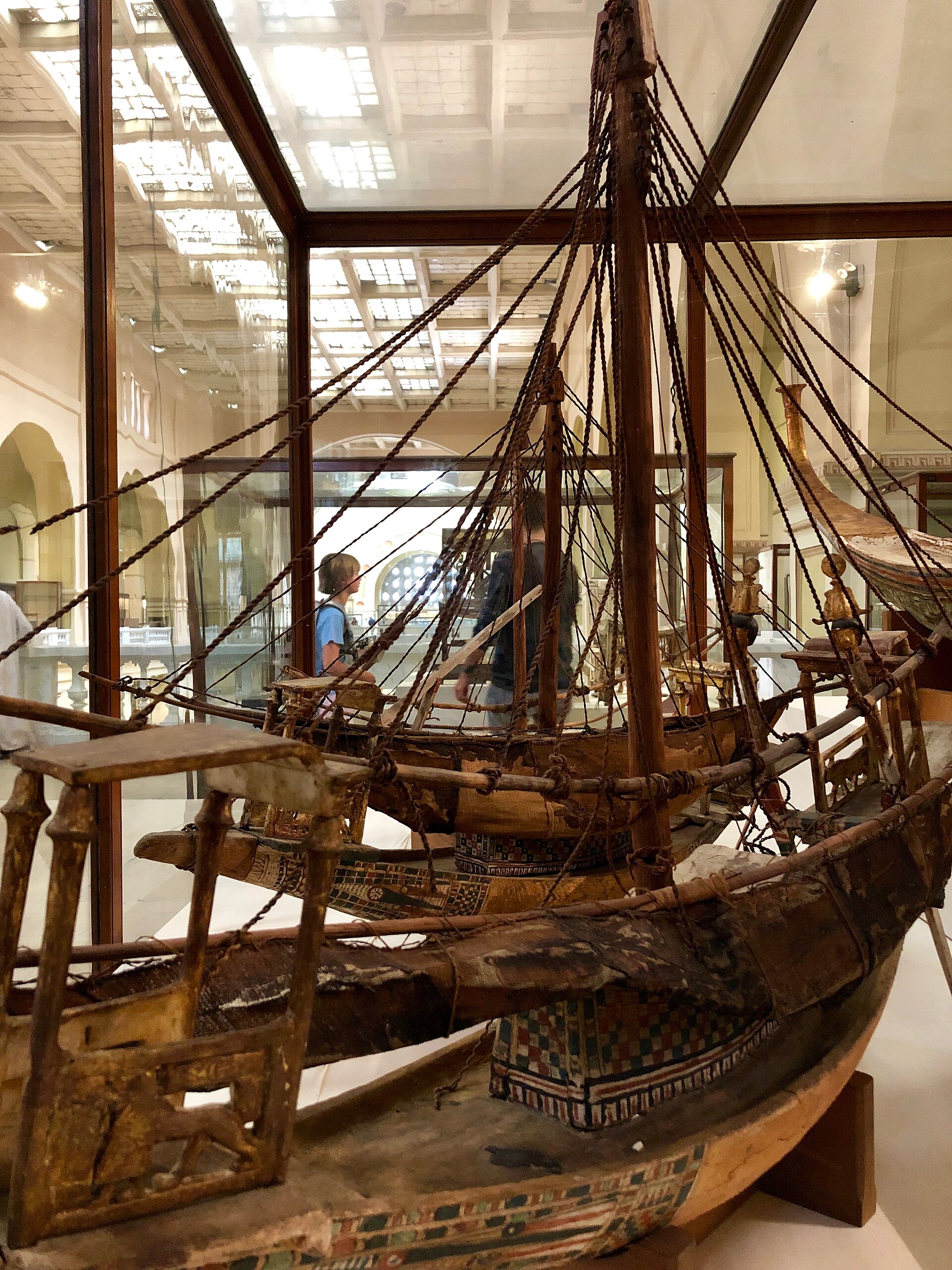 Model funerary boats with rigging in a glazed case on the upper-floor gallery
