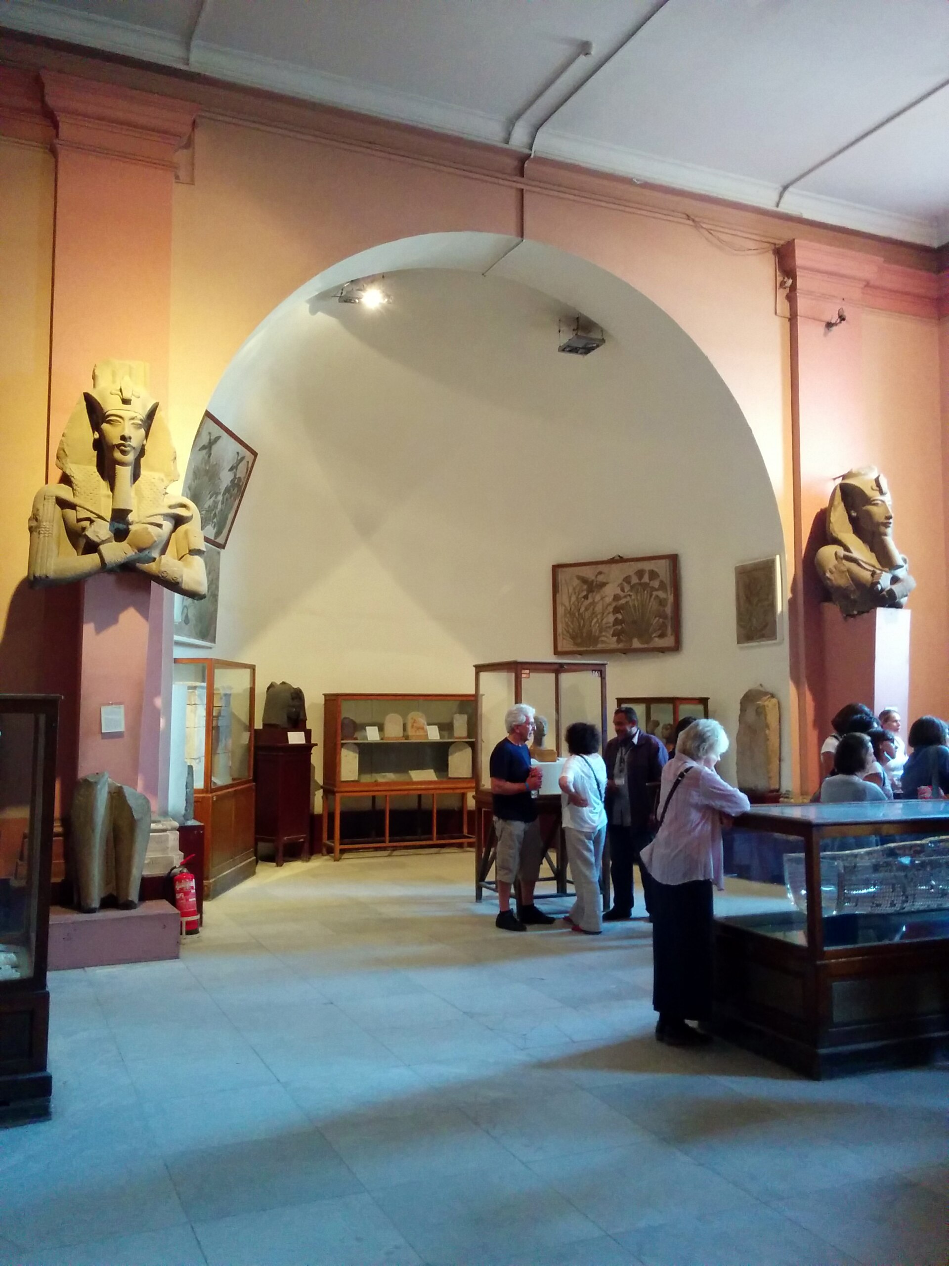 Colossal pillar-statue busts of Akhenaten flanking the arch of the Amarna gallery