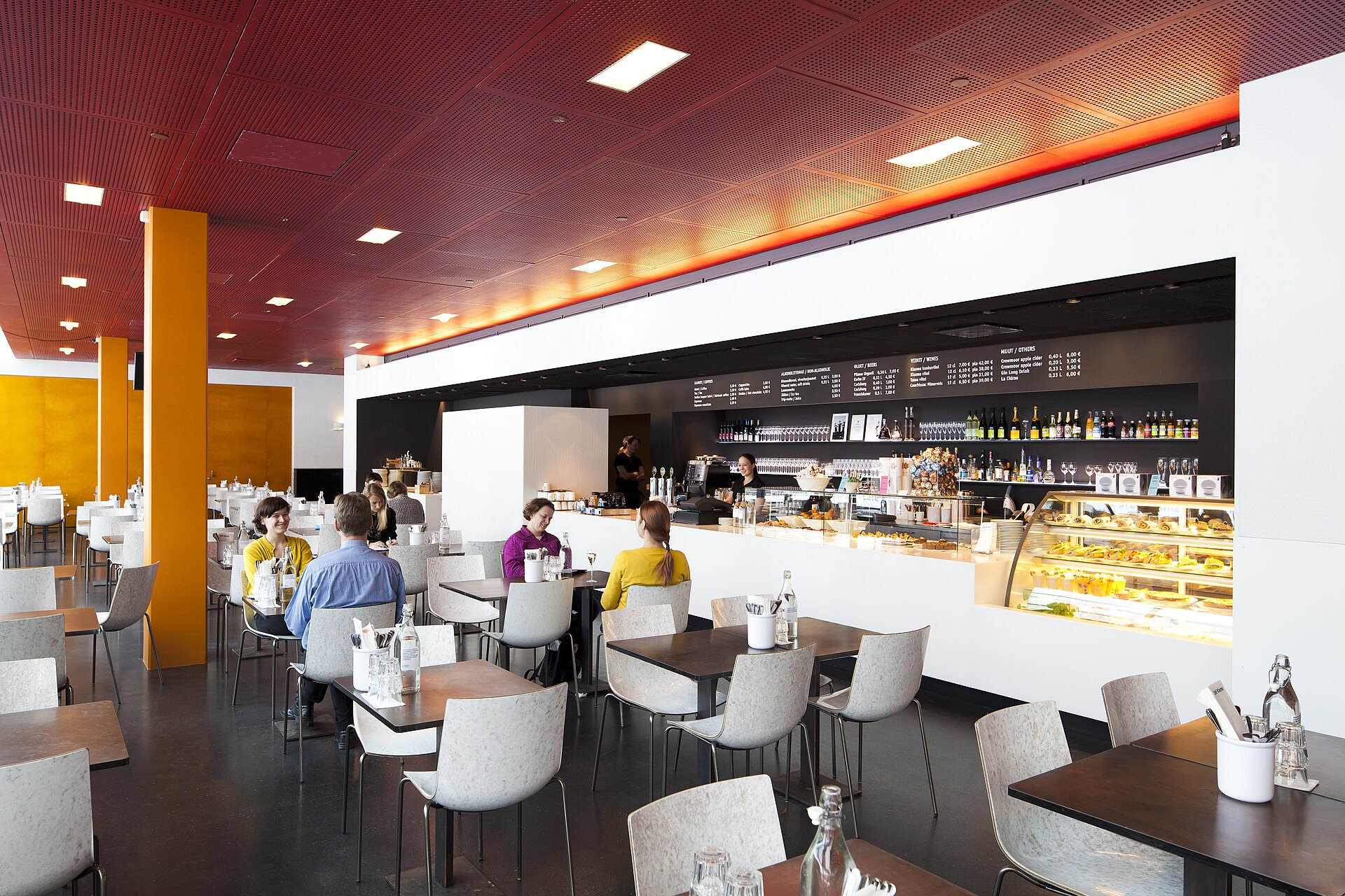 Cafe Kiasma's dining area with red ceiling panels and orange columns
