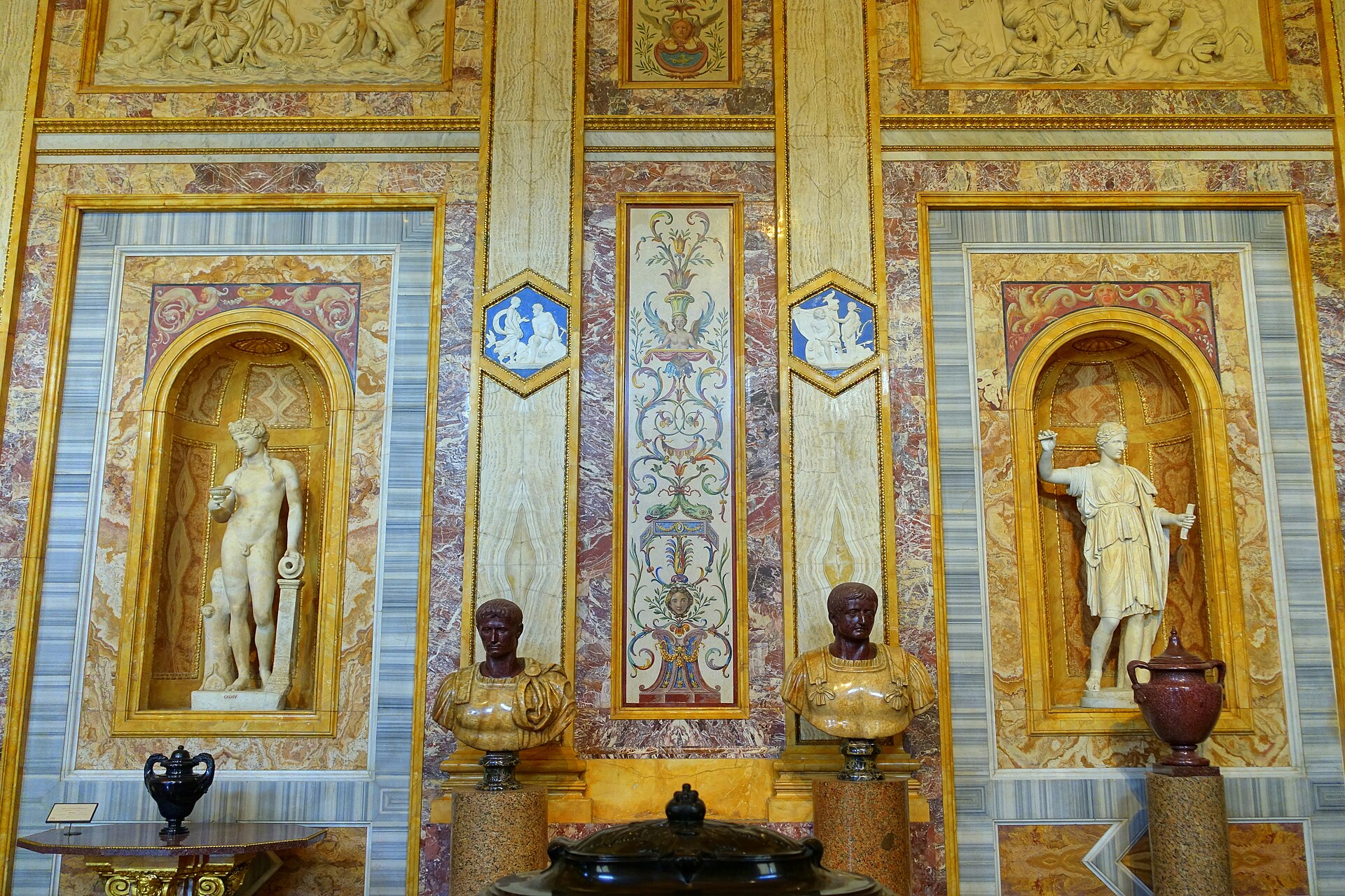 Porphyry and alabaster busts of the Caesars set into the marble-clad walls of the Room of the Emperors