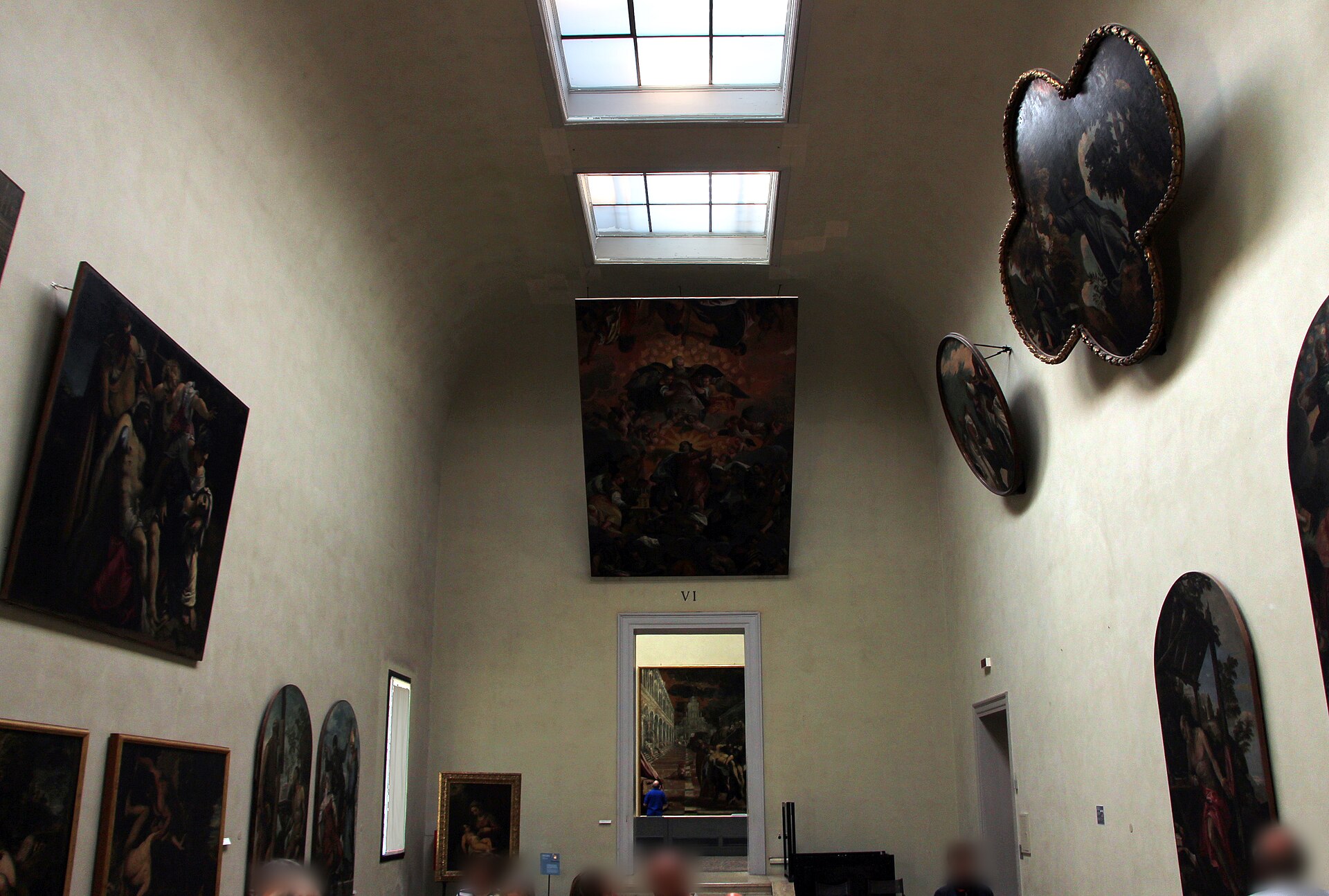 A first-floor room of the Gallerie dell'Accademia hung with Venetian Renaissance panel paintings and round-format tondi