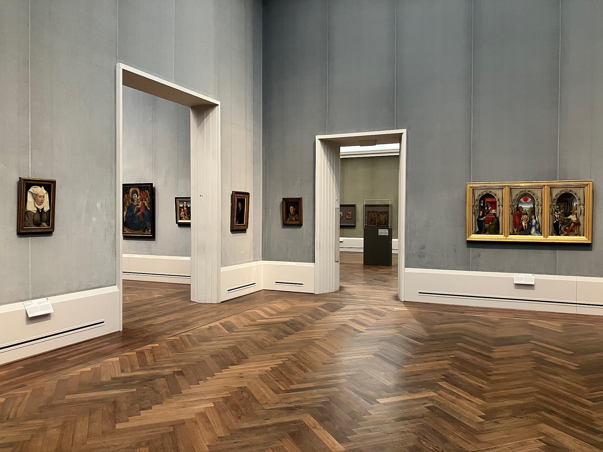 A Netherlandish gallery with early portraits and a gilt triptych