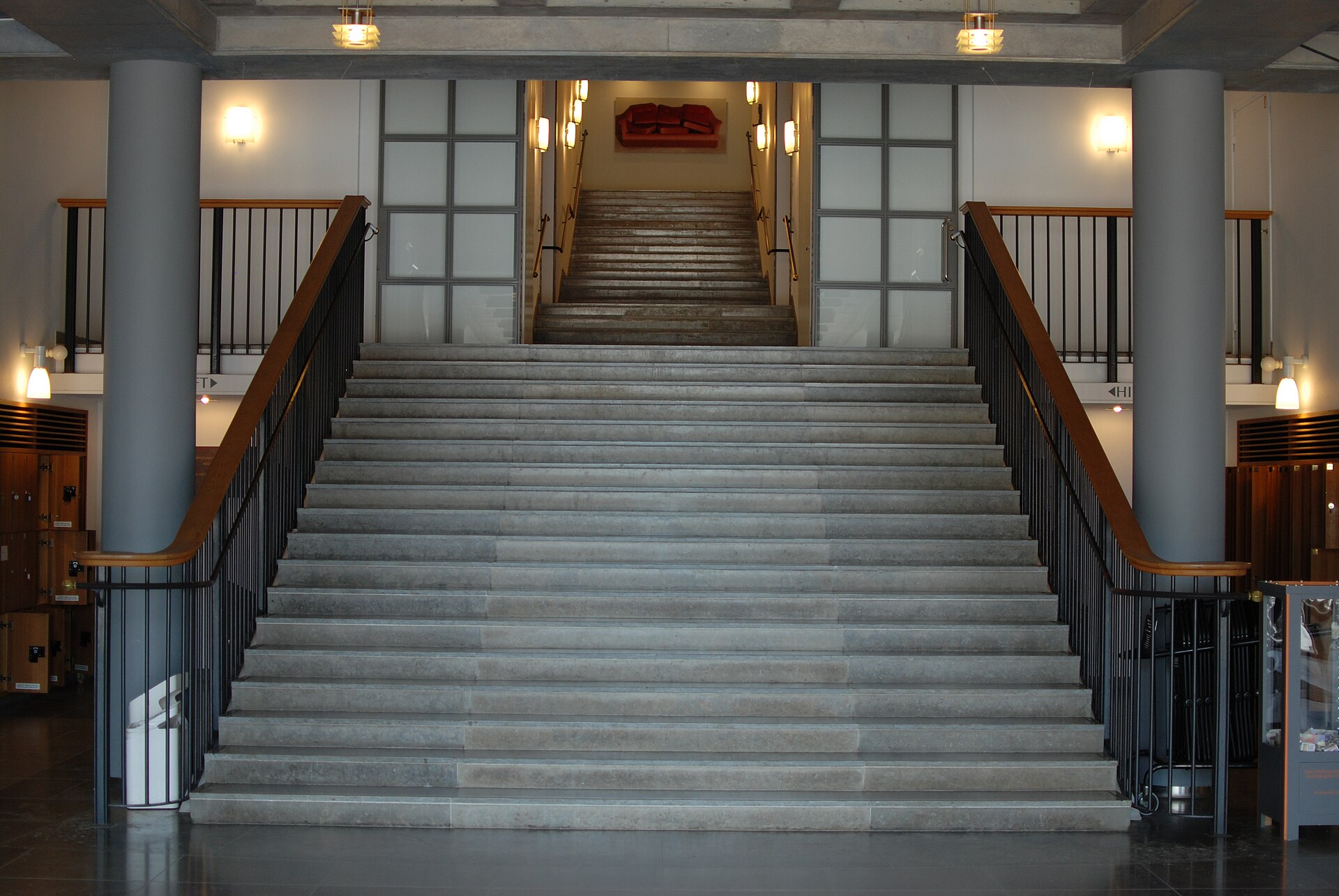 The grand concrete staircase inside the entrance hall of the museum, seen from the ground floor looking up