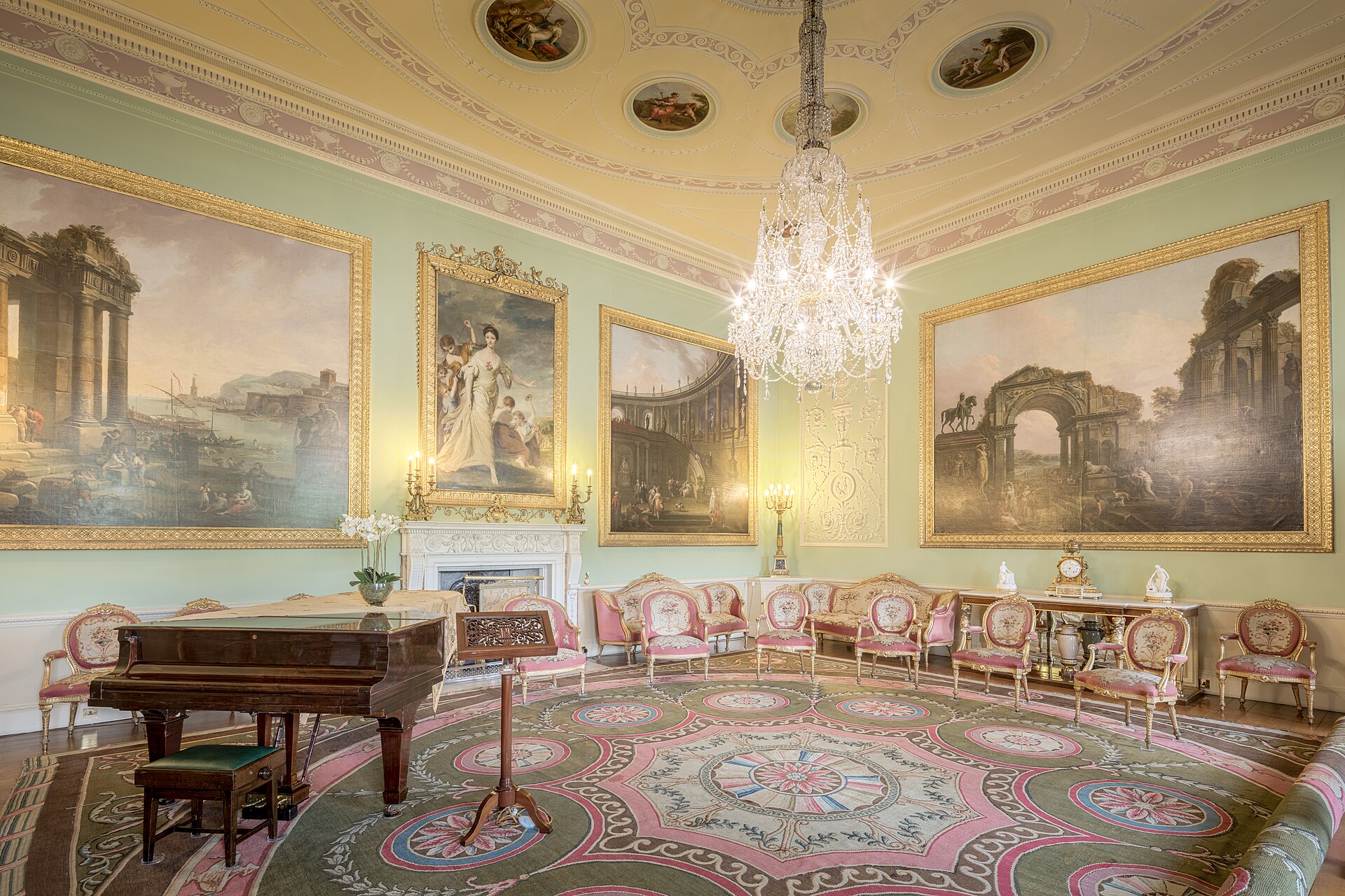 The Music Room, with its Robert Adam painted ceiling roundels, chandelier and grand piano