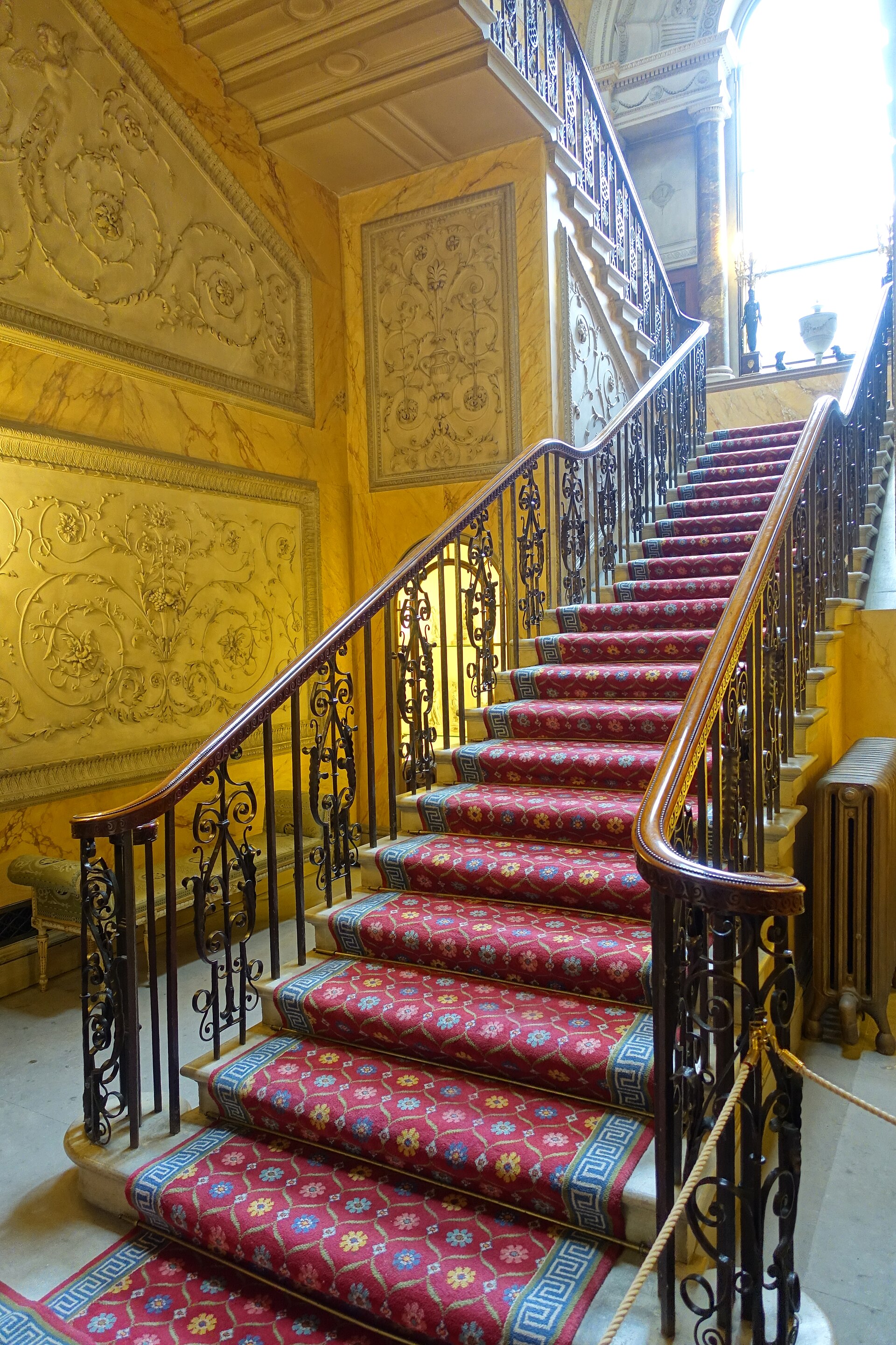 The Main Staircase, with its wrought-iron balustrade and painted walls