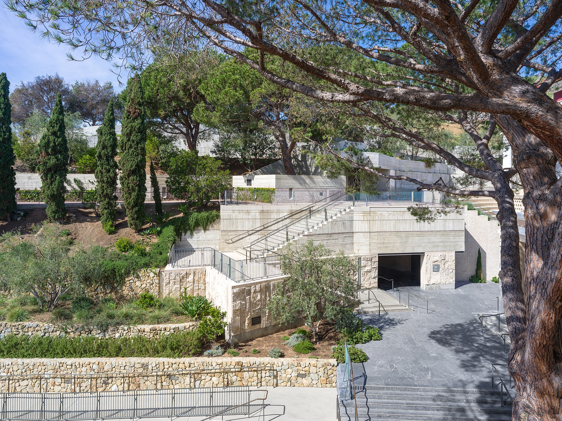 The terraced entry sequence and retaining walls leading down into the Getty Villa
