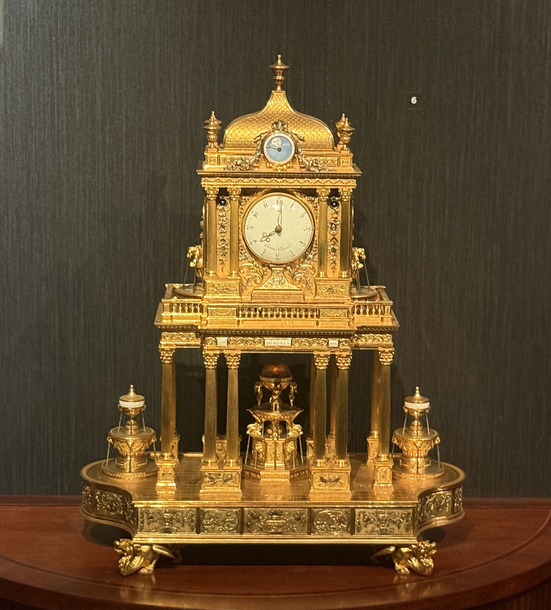 An ornate gilt mantel clock with a fountain automaton, from the museum's watch and clock galleries