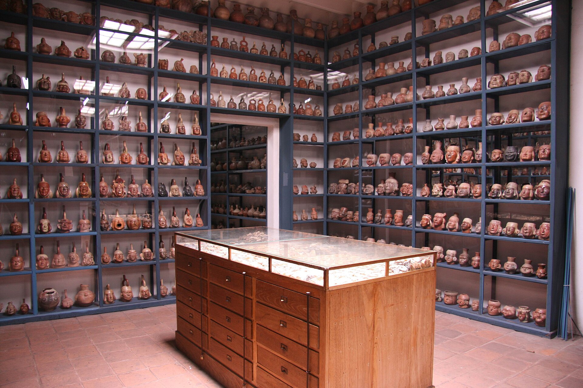 Floor-to-ceiling steel shelving holding thousands of catalogued pre-Columbian ceramic vessels in the Visible Storage gallery at Museo Larco
