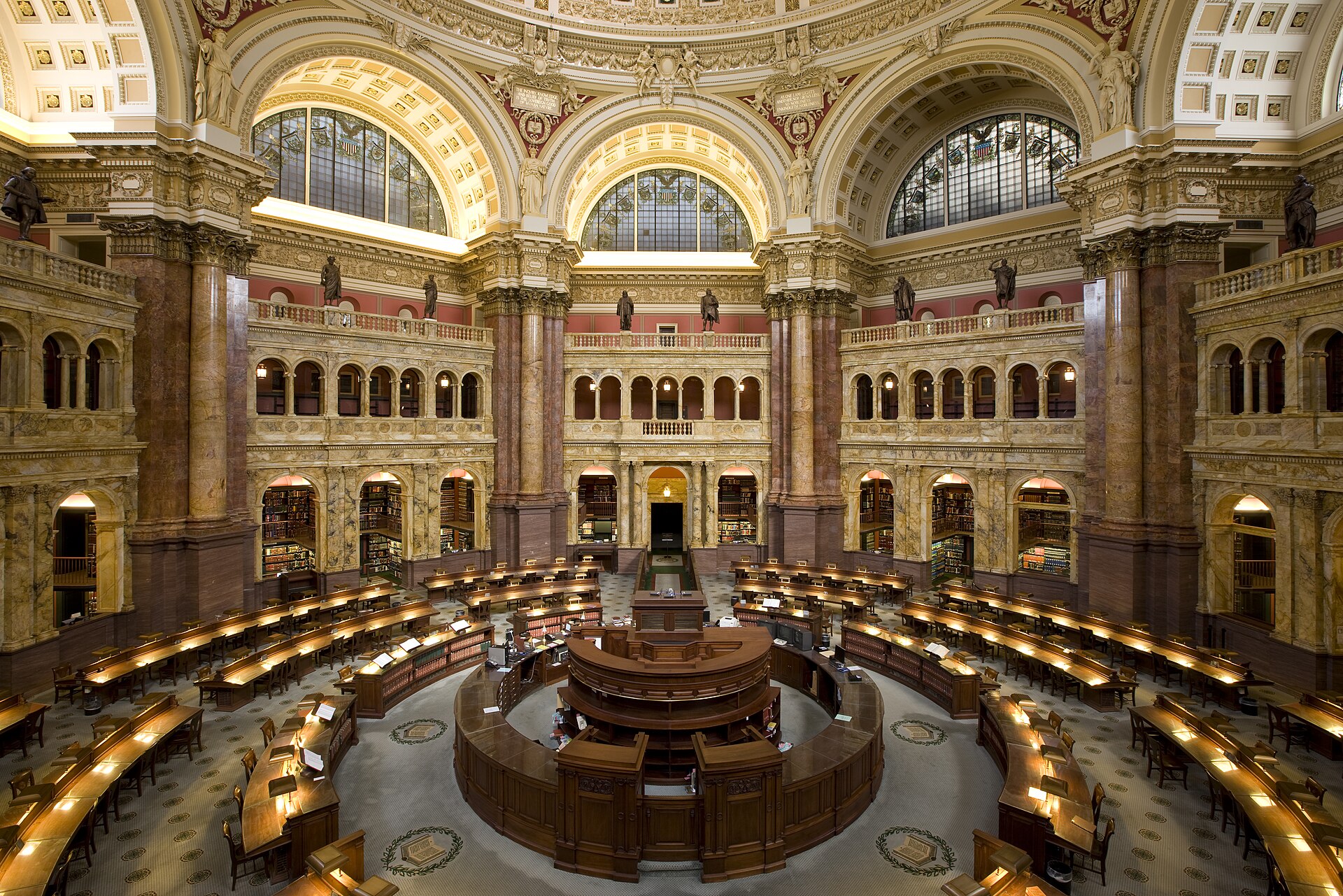 The domed Main Reading Room seen from above, ringed by desks and marble columns