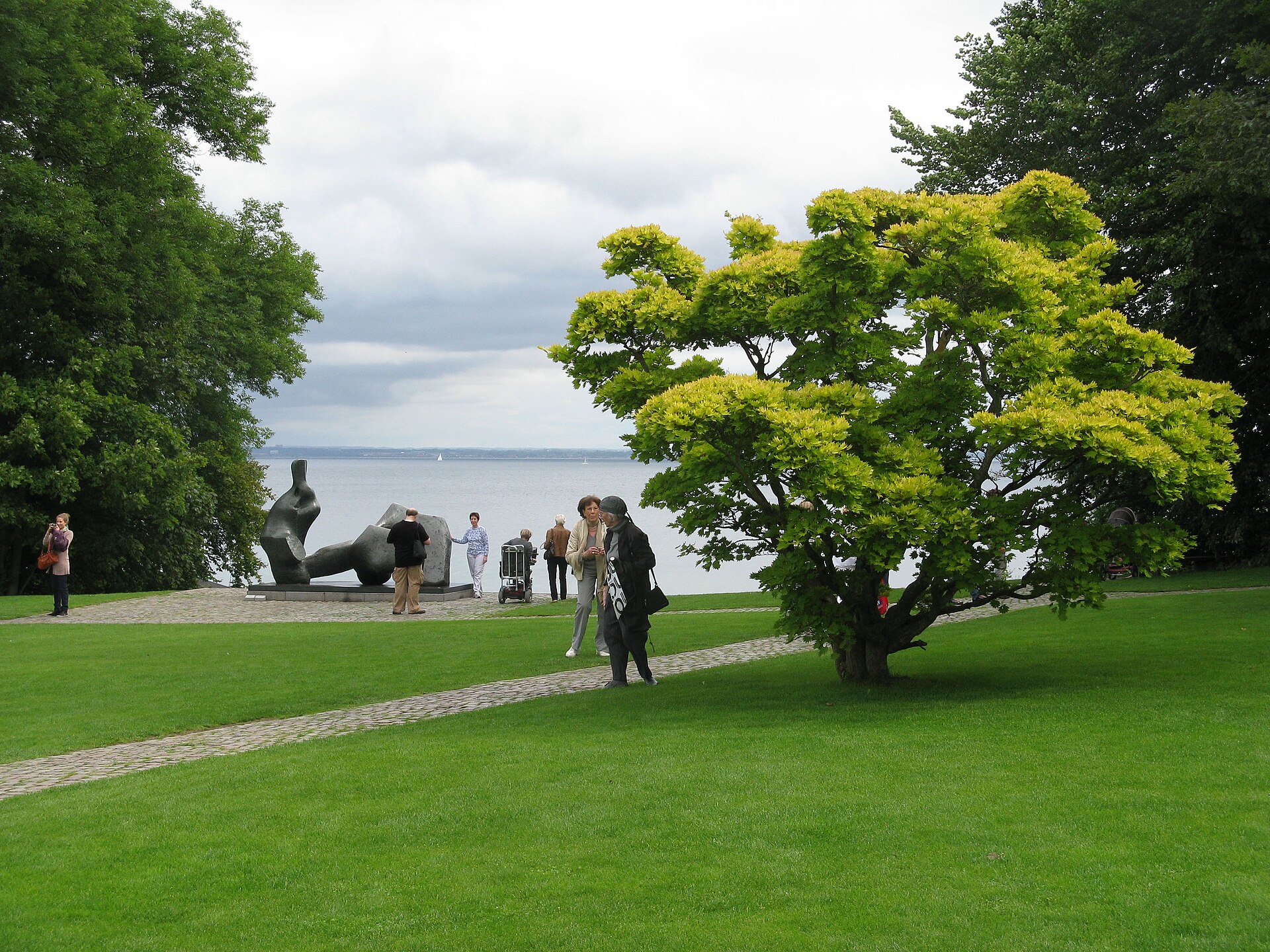 Sculpture park lawn sloping to the Sound, with a Henry Moore bronze figure in the middle distance