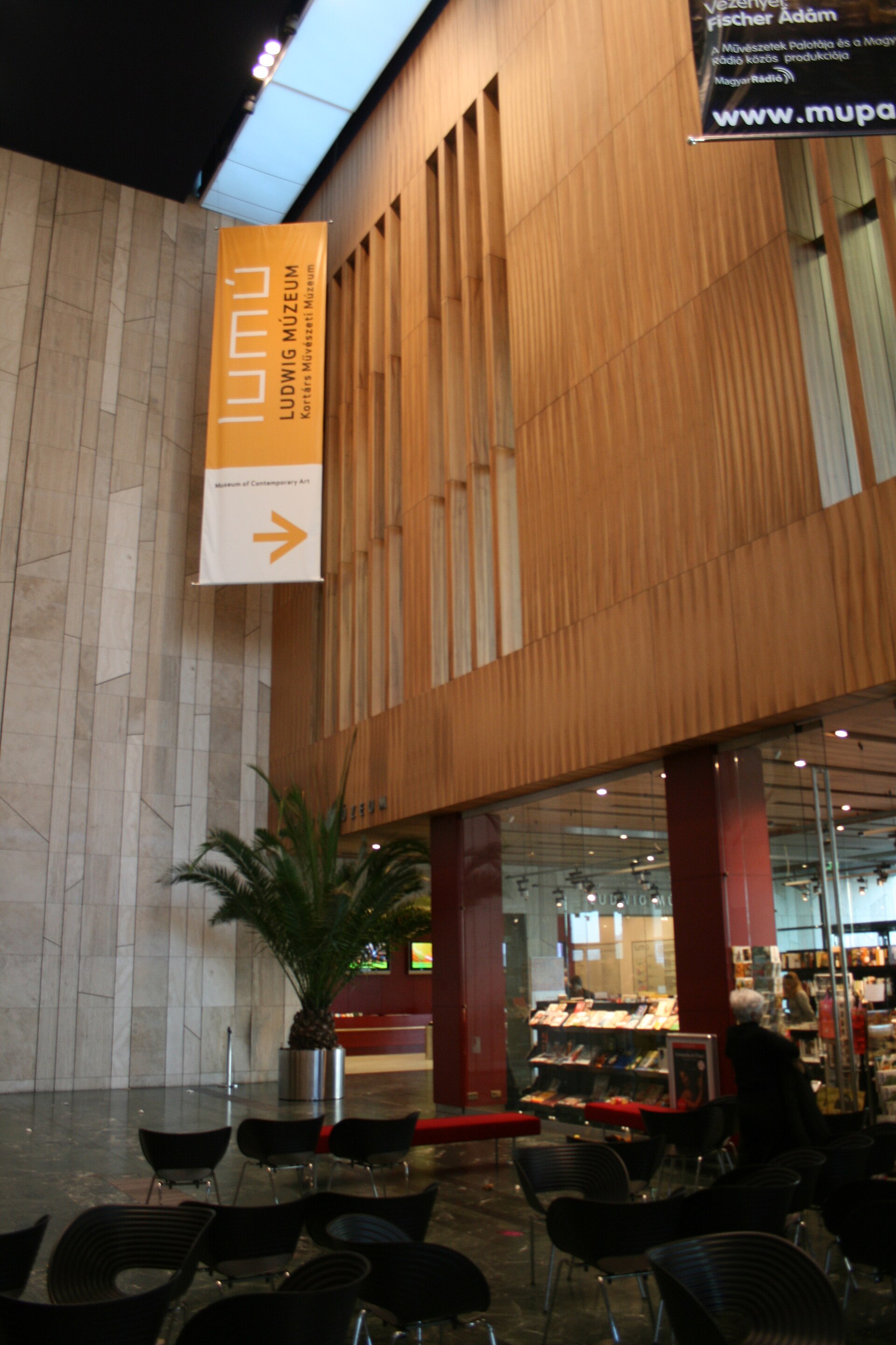 The Ludwig Museum's ground-floor lobby with the LUMU sign directing visitors toward the museum entrance and bookshop