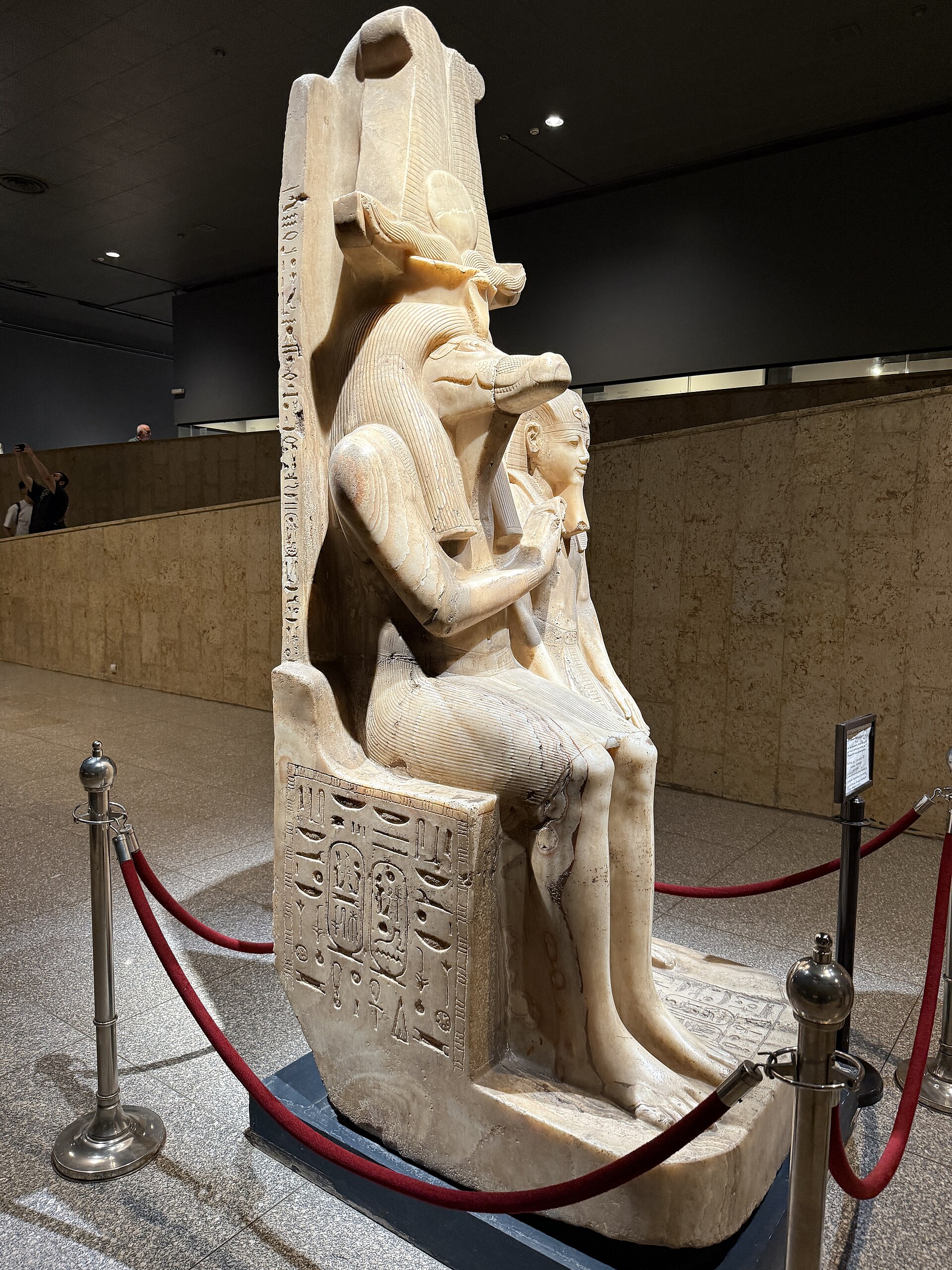 The seated calcite statue of the crocodile god Sobek with the young pharaoh Amenhotep III, roped off in a gallery hall