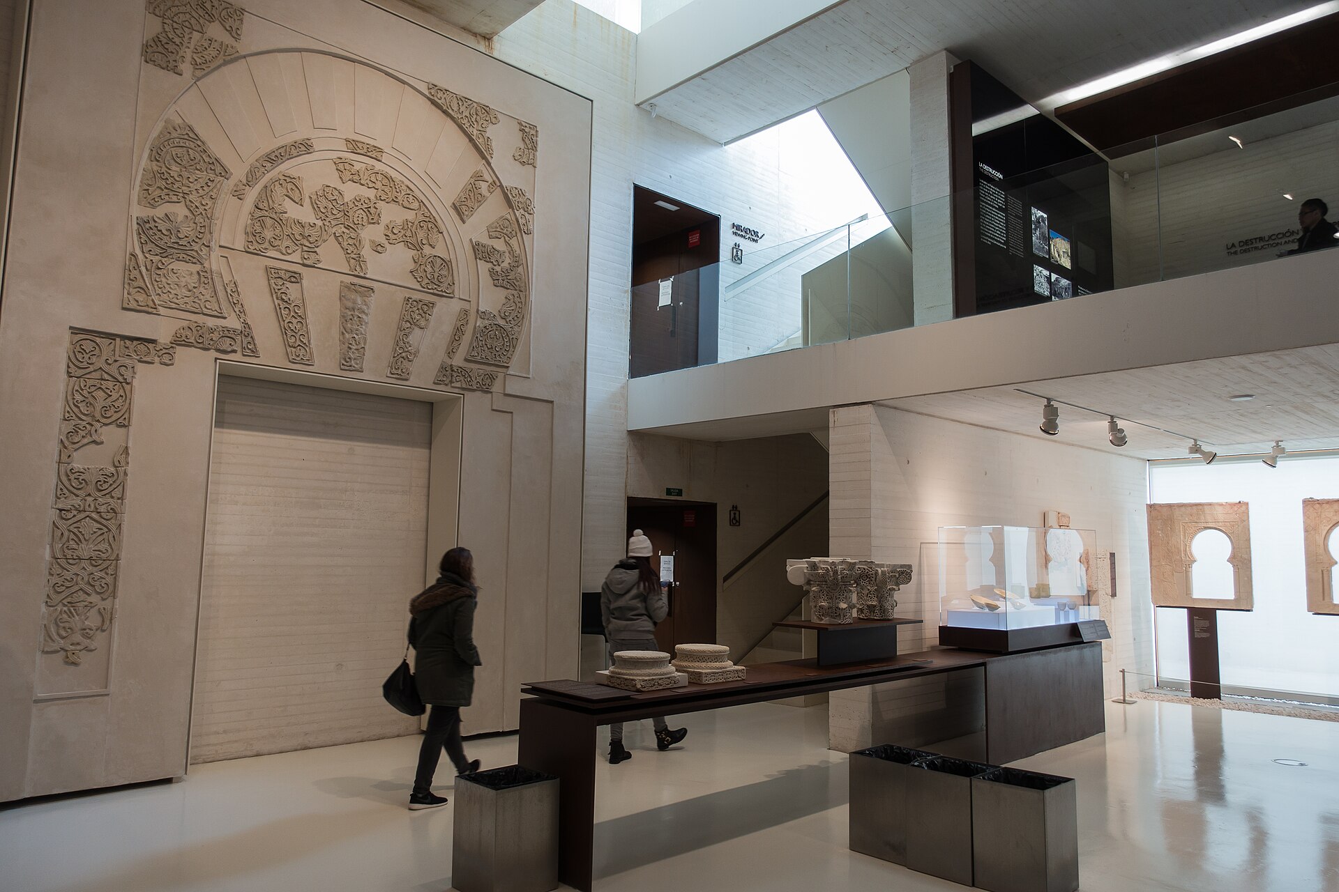 Display cases holding carved marble capitals and architectural fragments in the museum's exhibition hall