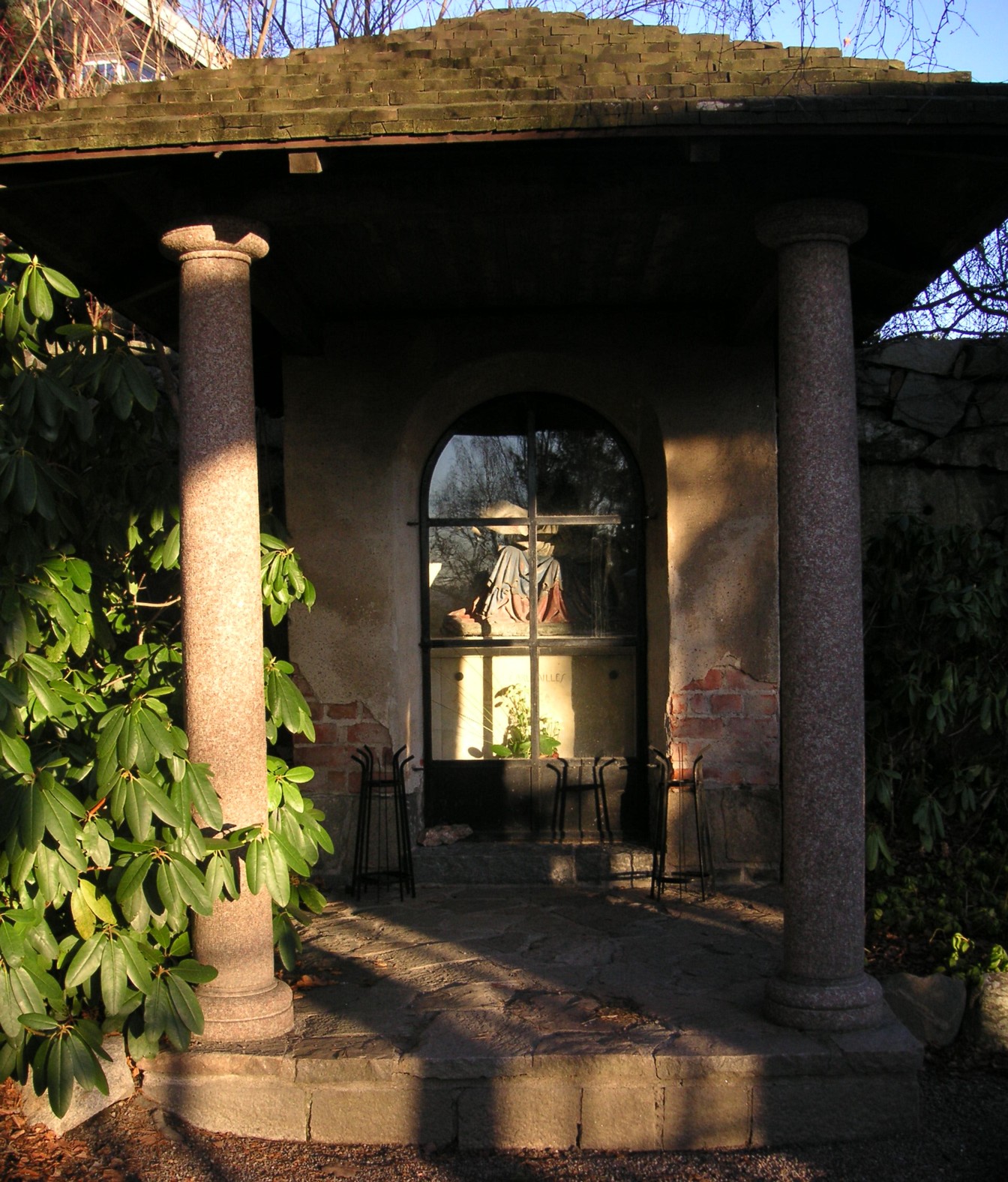 A small stone chapel with granite columns and an arched window, the Milles family burial place