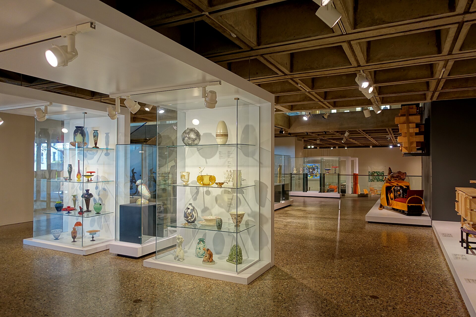 Decorative arts and design display cases in the Stewart Pavilion, under its exposed concrete coffered ceiling