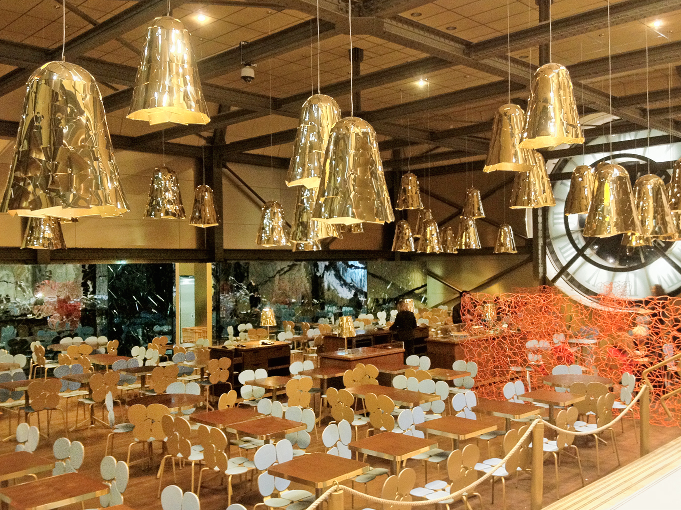 Cafe Campana, with the Campana brothers' gilt pendant lamps and the great clock face visible behind