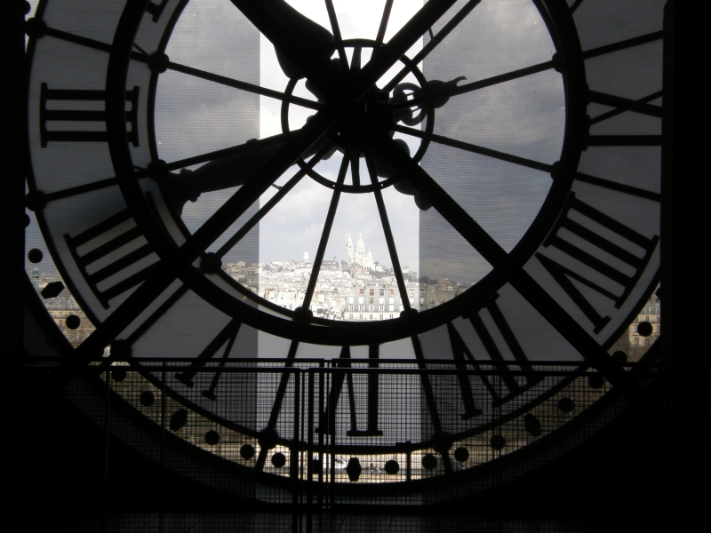 Sacre-Coeur seen through the glass face of the museum's great clock