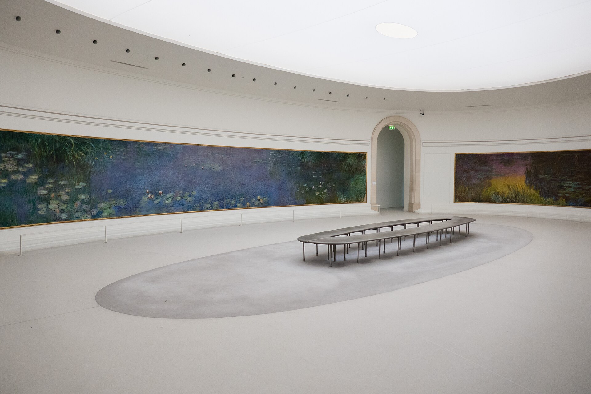 One of the two oval Water Lilies rooms, showing Monet's panels curving along the wall beneath the skylight
