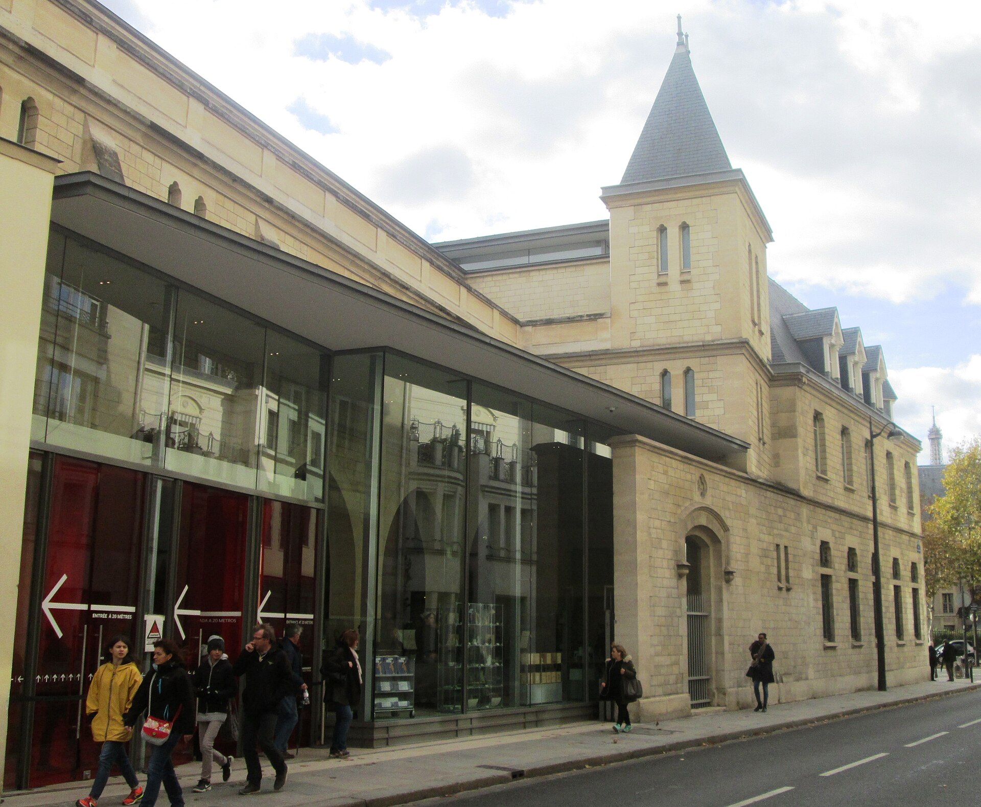 The glass-fronted modern entrance pavilion set into the older stone gatehouse