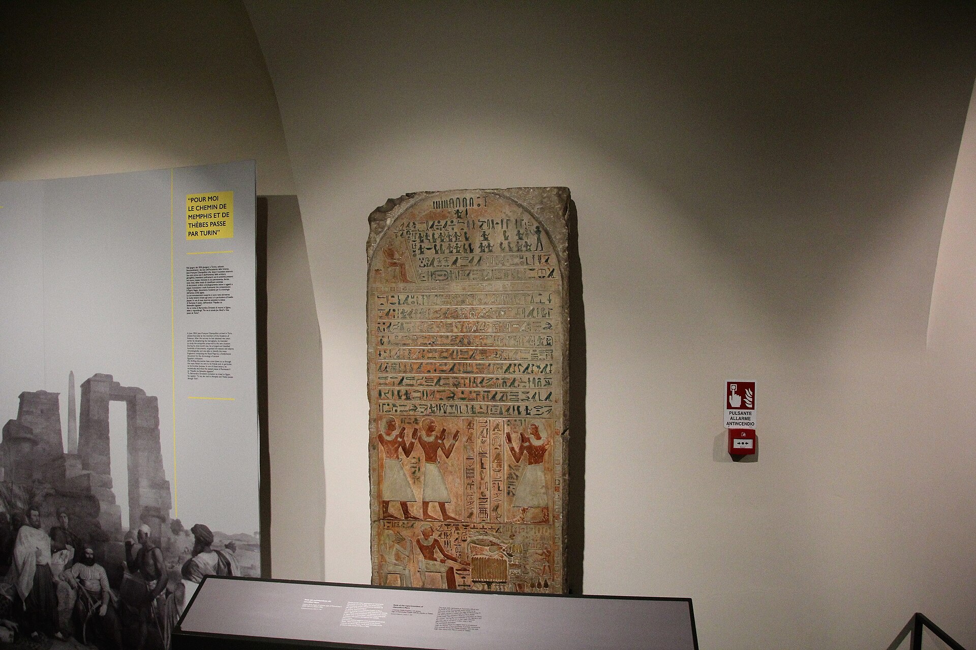 An inscribed funerary stela on display, with an explanatory panel quoting Champollion's remark that the road to Memphis and Thebes passes through Turin