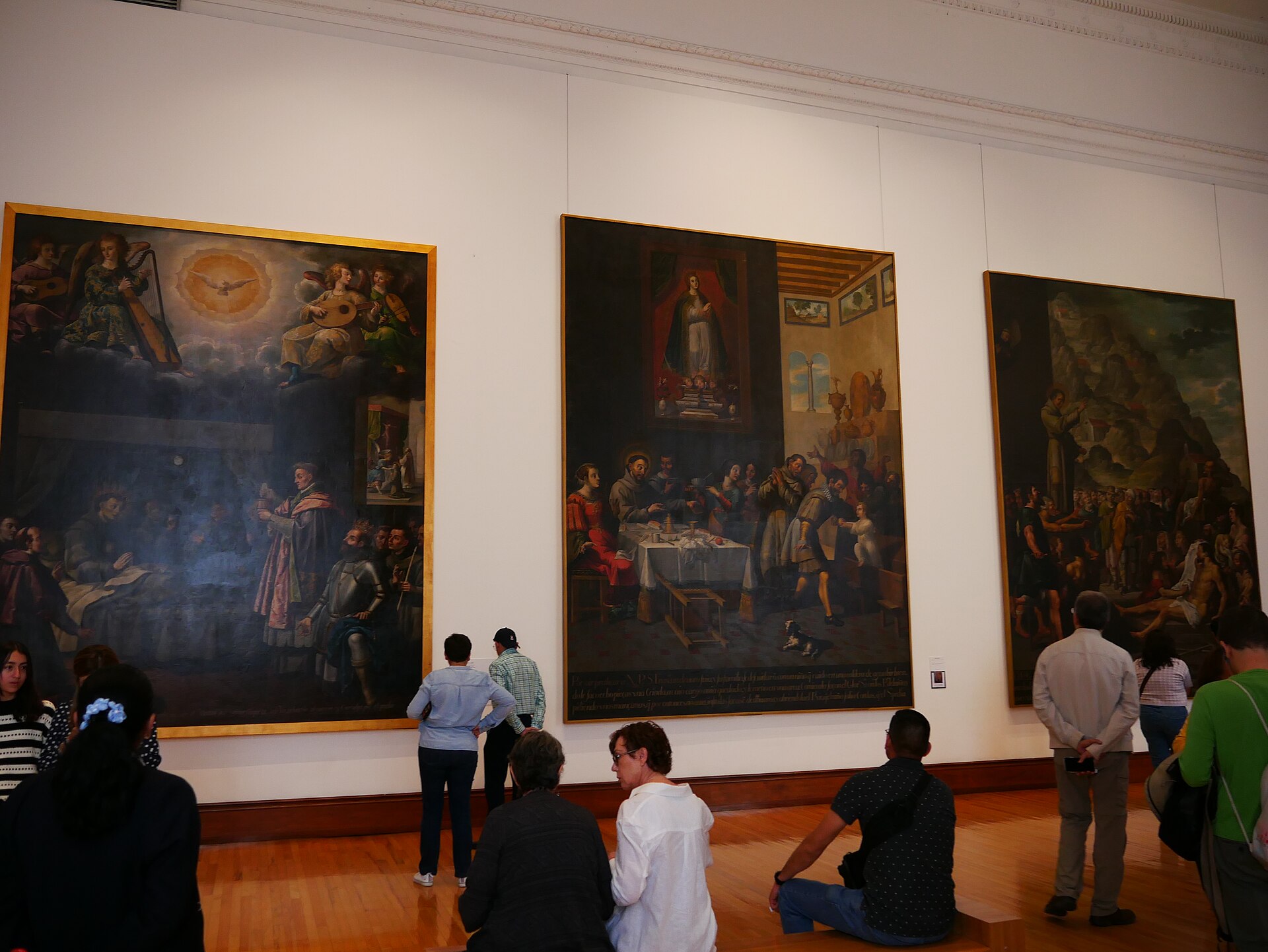 A gallery of large gilt-framed viceregal religious paintings at the Museo Nacional de Arte