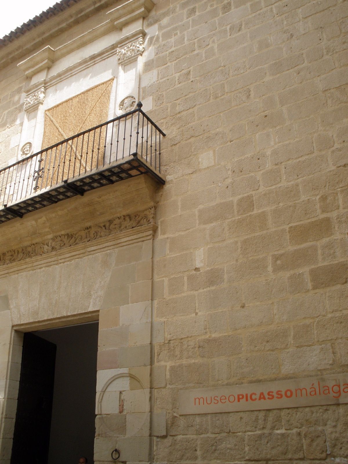 Excavated stone wall remains under artificial lighting in the museum's basement