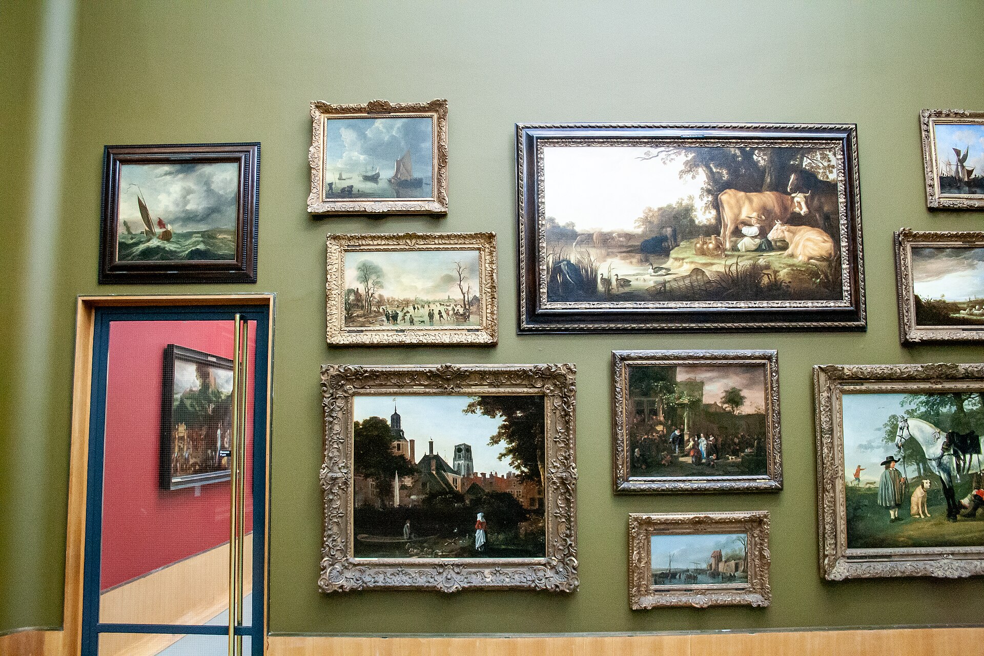 A gallery wall in the museum's Old Masters hang, before the 2019 closure, densely hung with Dutch seventeenth-century marine, landscape and genre paintings in gilt frames