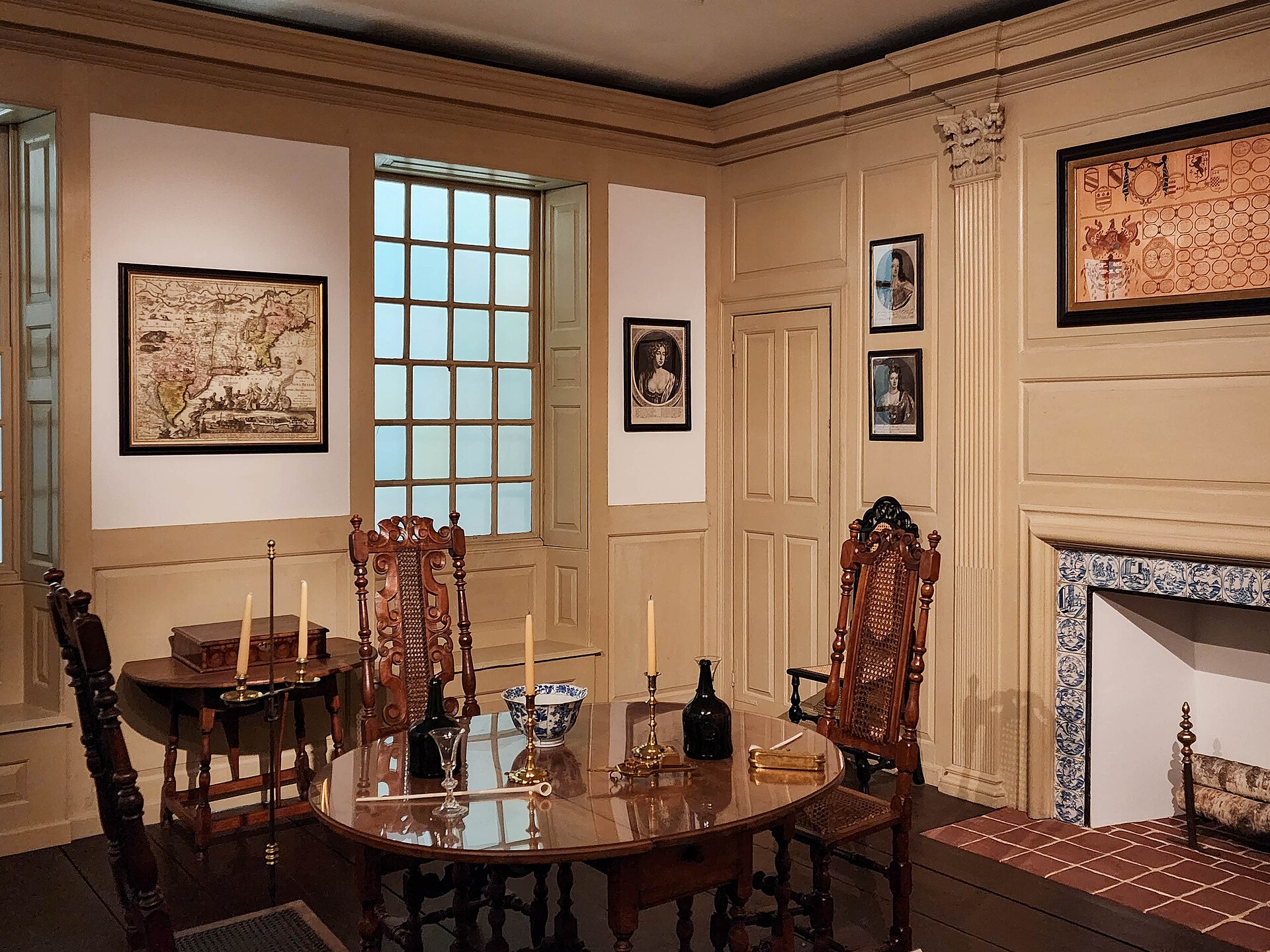 A reconstructed seventeenth-century New England room, with a period map, delft-tiled fireplace and joined furniture