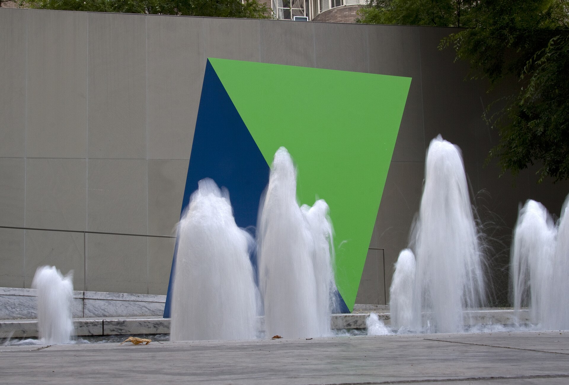 Fountains playing in front of a geometric wall relief in MoMA's Abby Aldrich Rockefeller Sculpture Garden