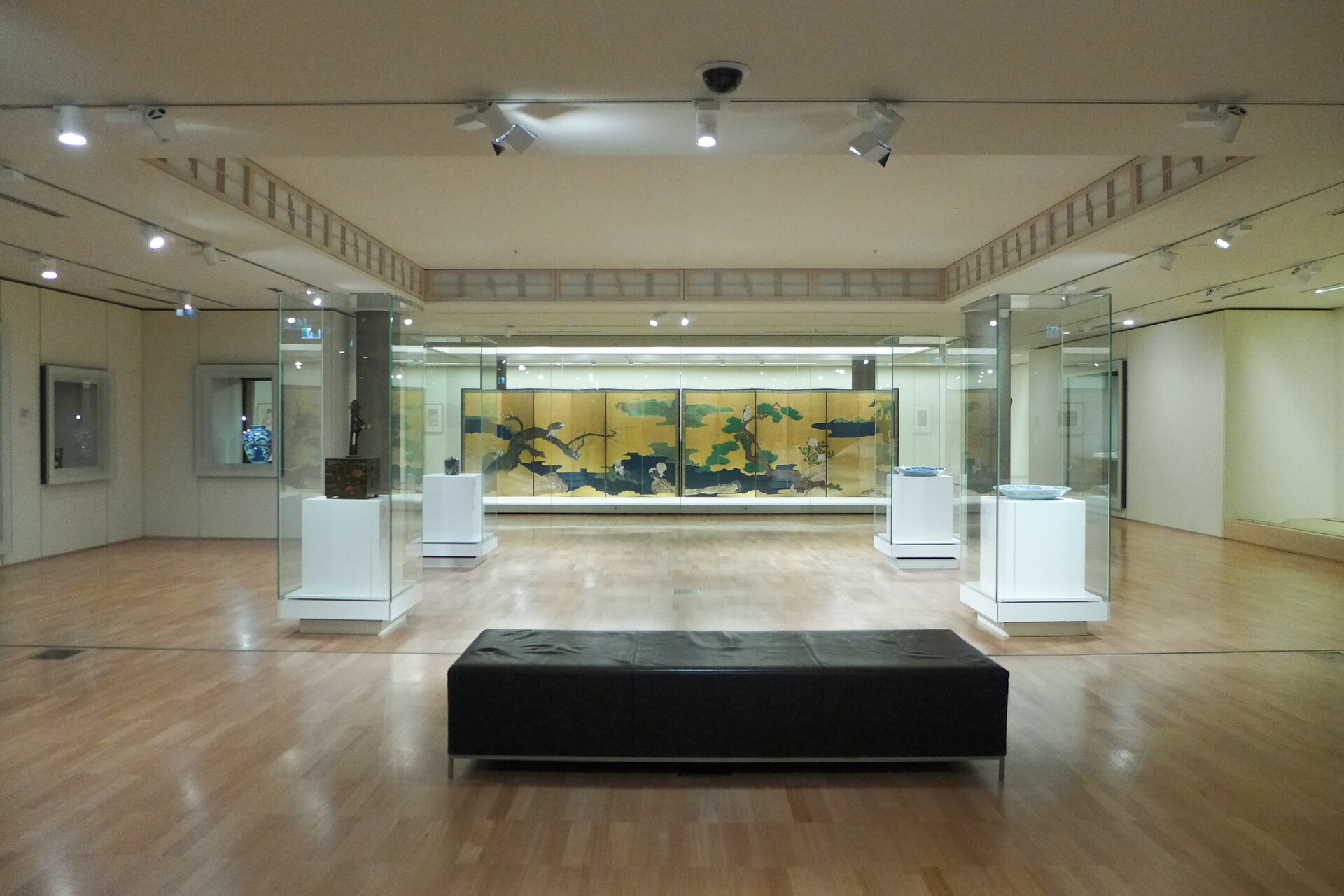 A gallery of Japanese screens and ceramics in glass cases