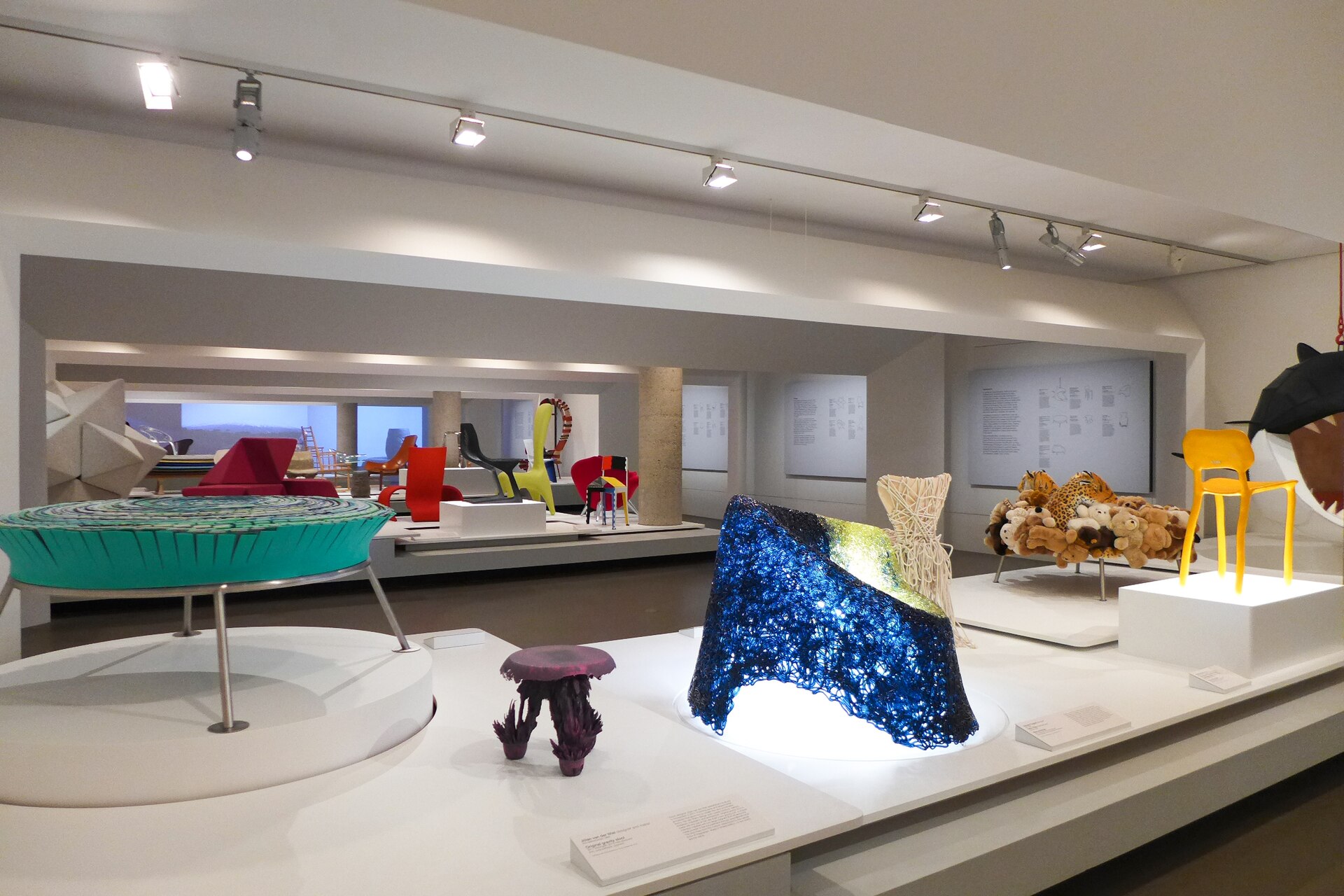 A contemporary design gallery with sculptural furniture and objects on plinths