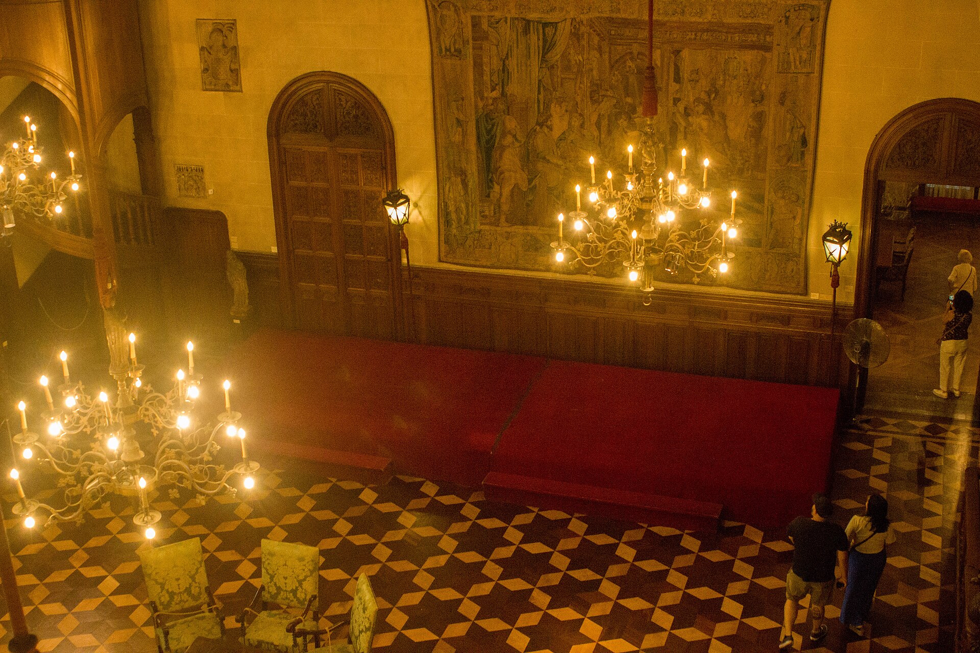 The Great Hall of the Museo Nacional de Arte Decorativo, seen from the first-floor gallery, showing its coffered wooden ceiling and sixteenth-century tapestries