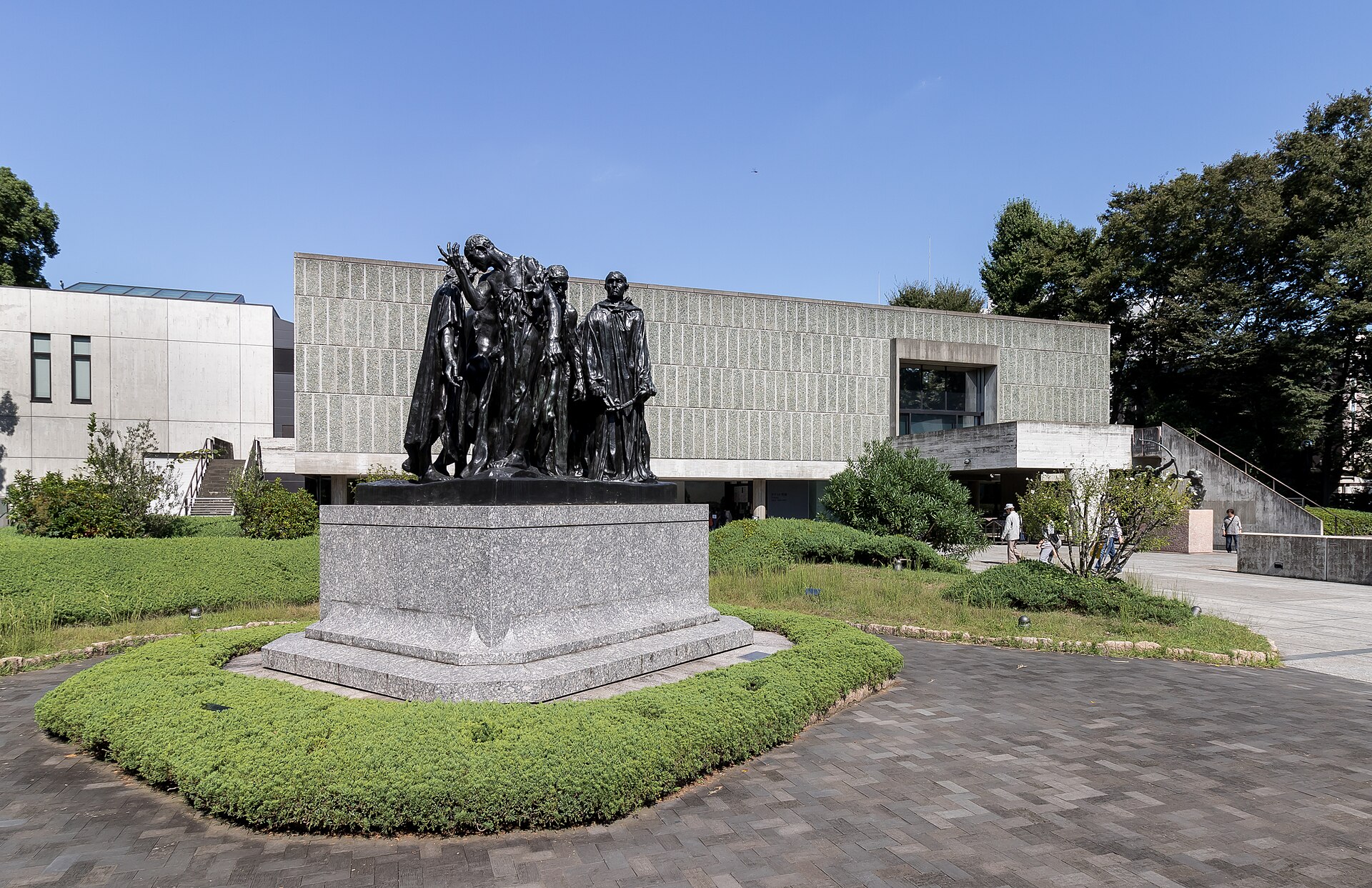 Rodin's The Burghers of Calais standing in the museum's forecourt, with the Main Building behind