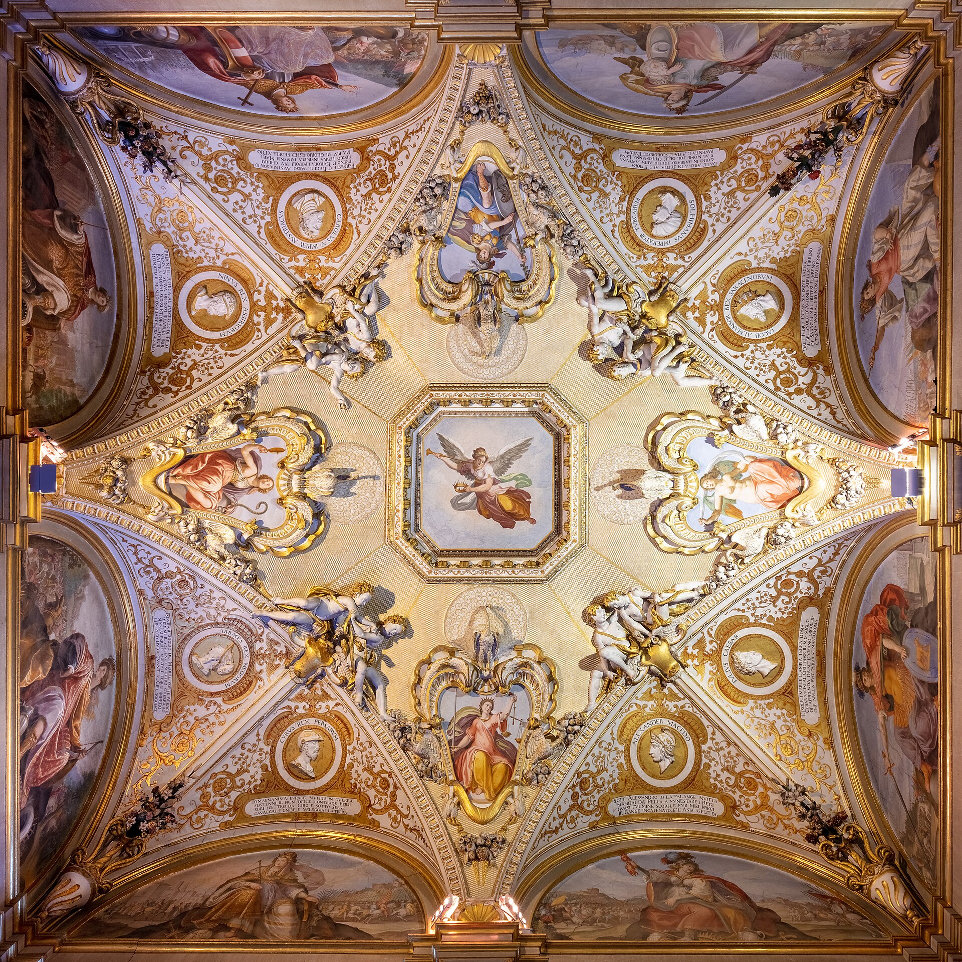 The frescoed ceiling of the Sala della Stufa, with painted medallions and stucco figures