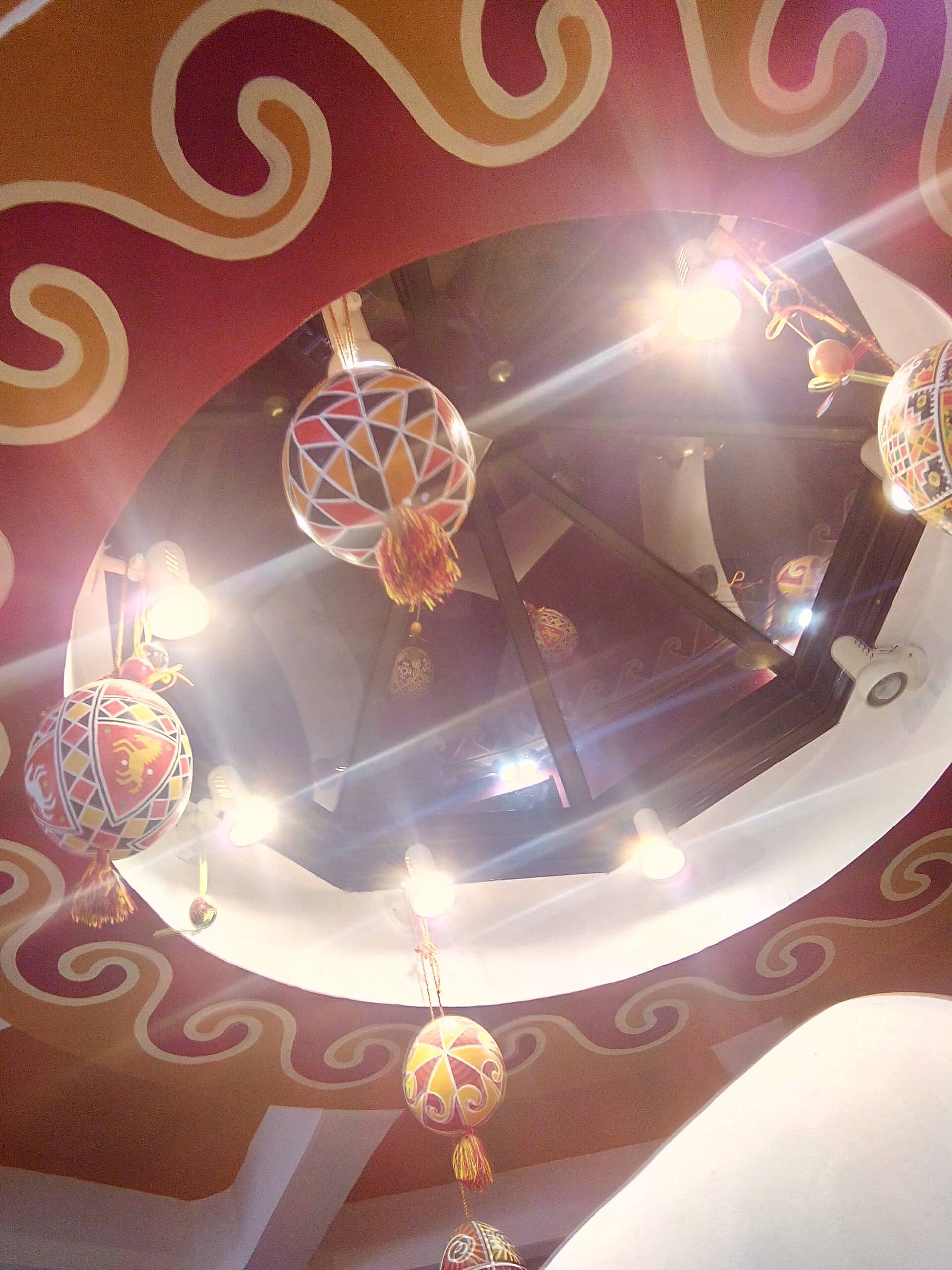 The painted dome ceiling of the museum's main hall, hung with giant decorated eggs