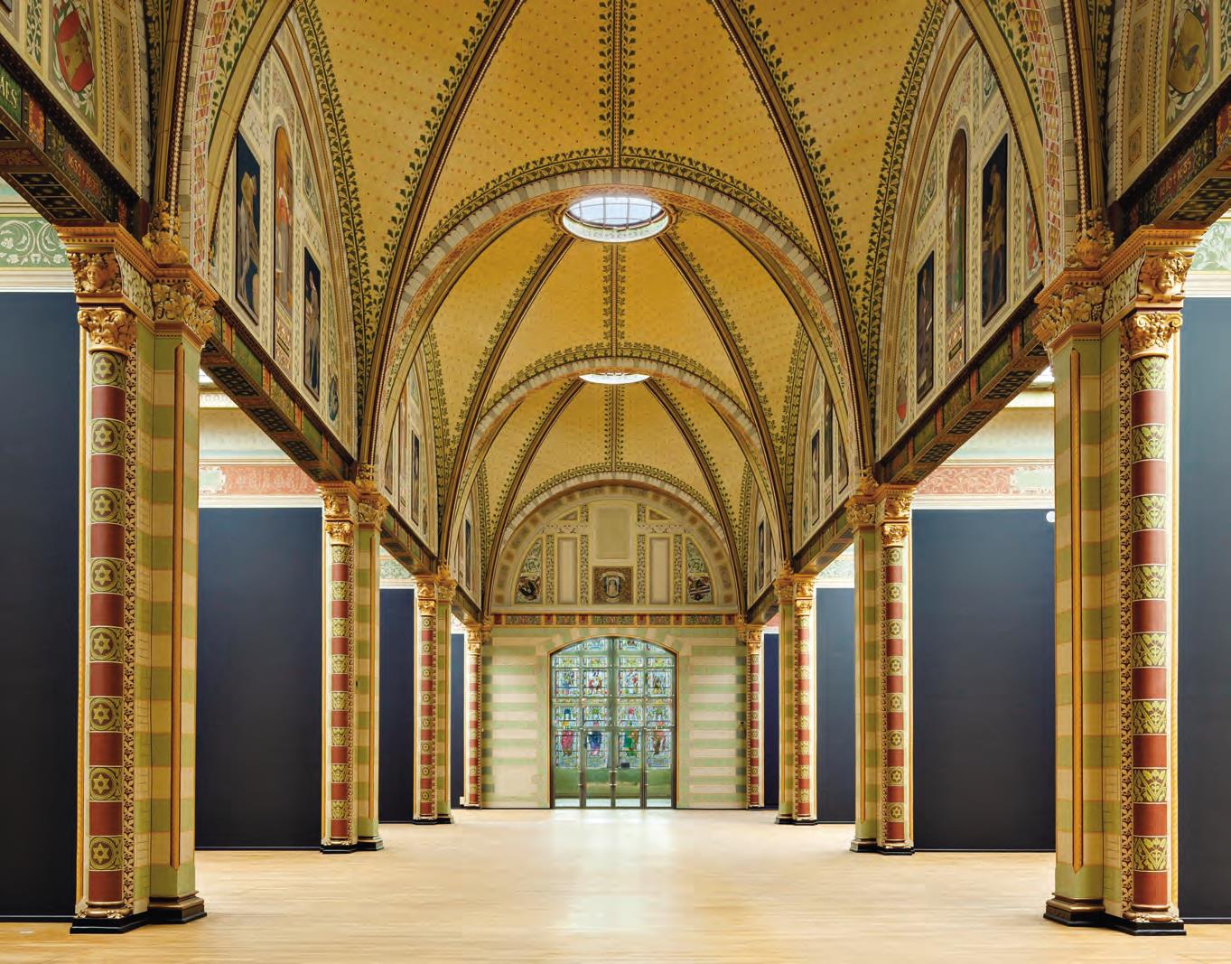 The Gallery of Honour empty after the rebuild, showing the restored painted vaults and the side cabinets