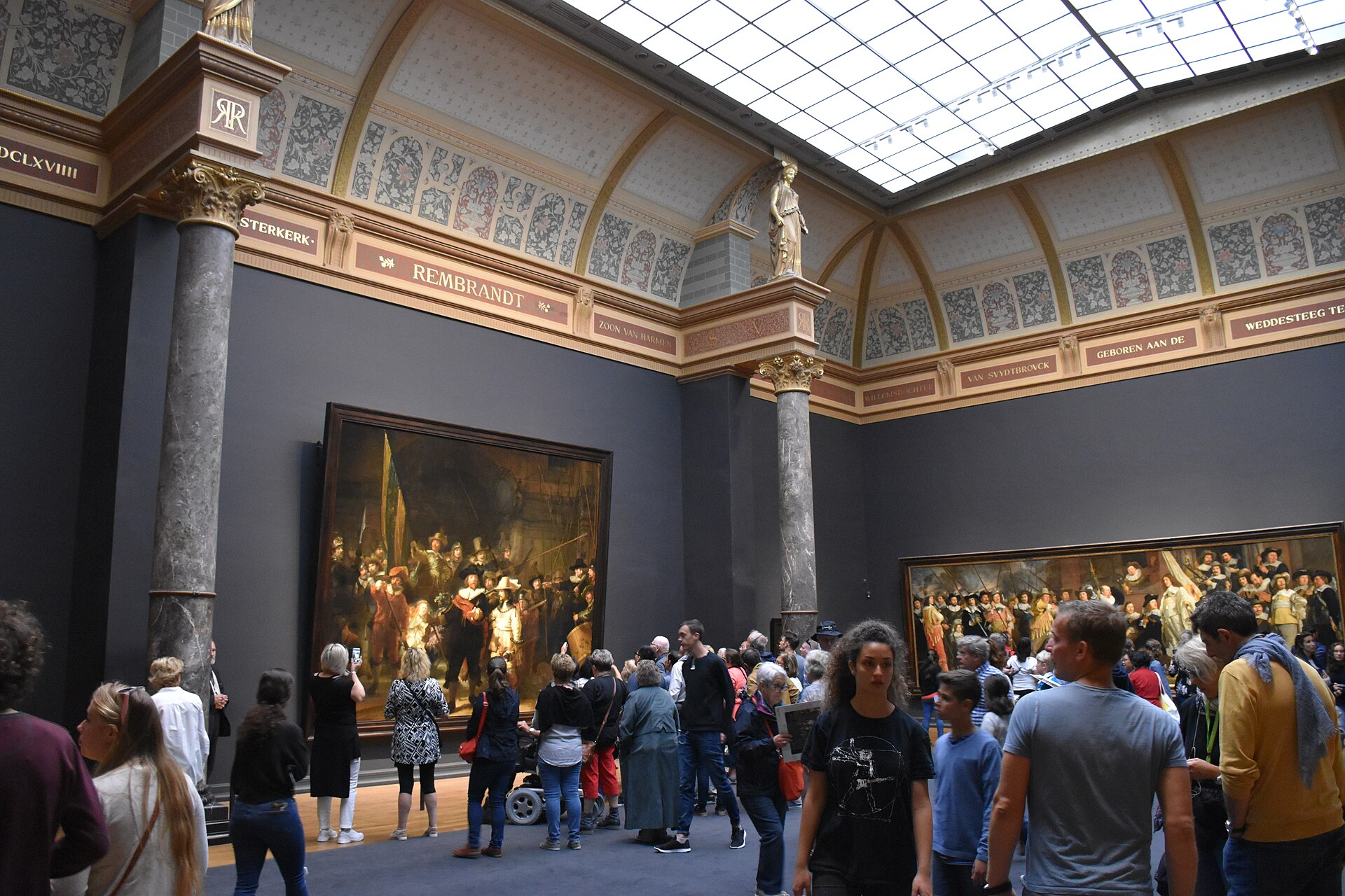 The Night Watch on the end wall of its own gallery with a crowd in front of it