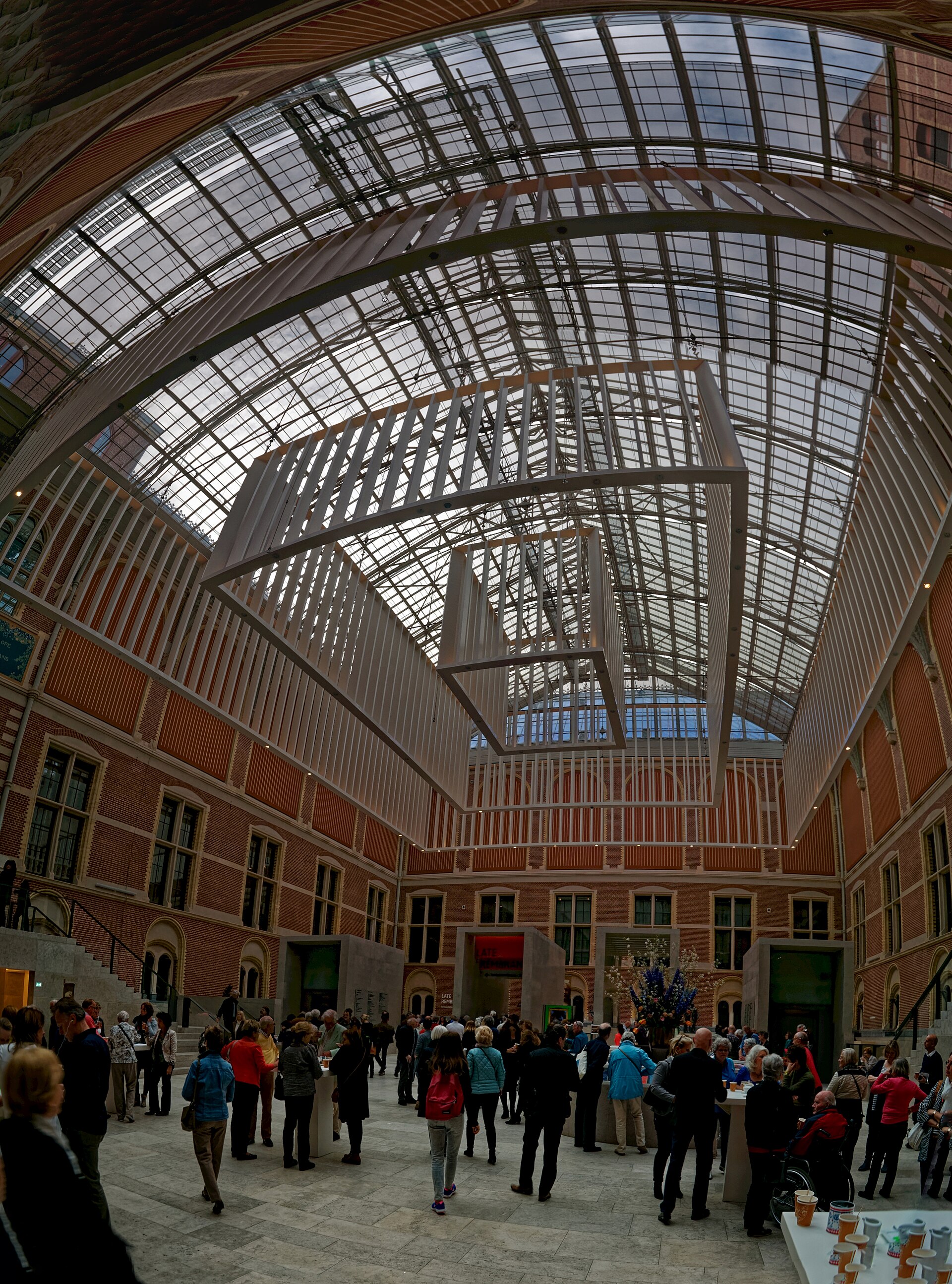 The Atrium under its glass roof, with visitors on the pale stone floor